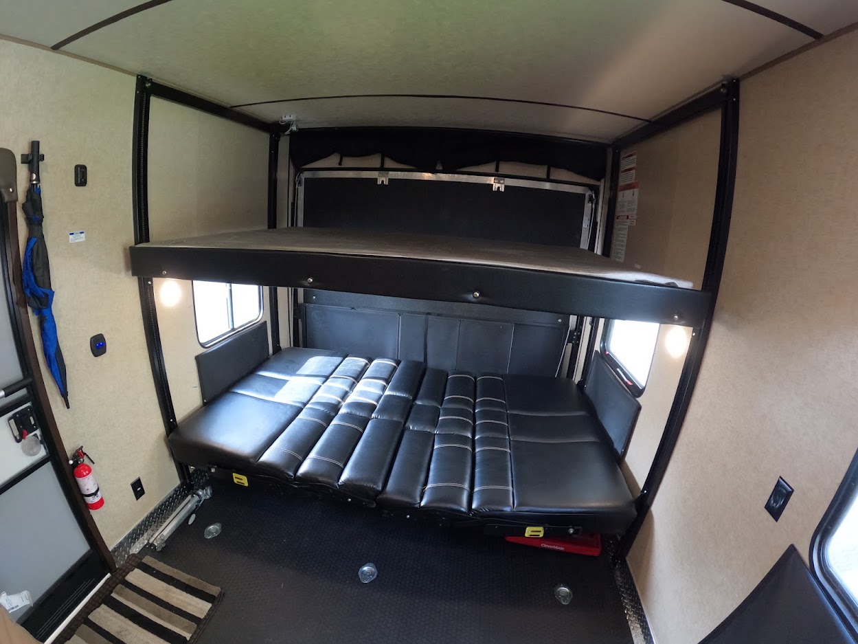 RV rental: Interior shows a toy hauler's versatile sleeping area with a lower convertible bed and an upper bunk.. Forest River XLR Boost Toy Hauler 2018