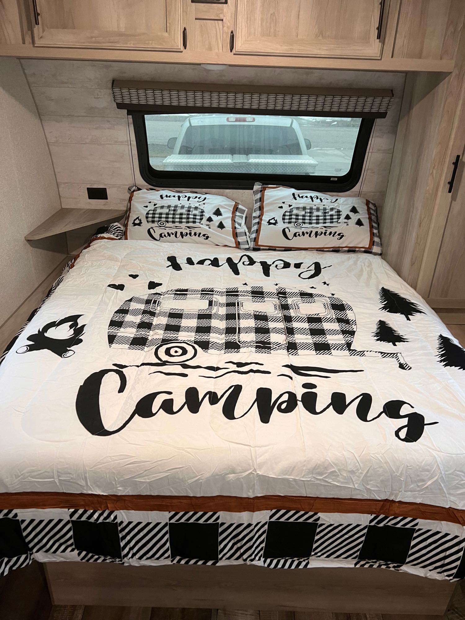 Cozy RV rental bedroom with camping-themed bedding, ideal for a comfortable stay.. Escape e231bh 2022