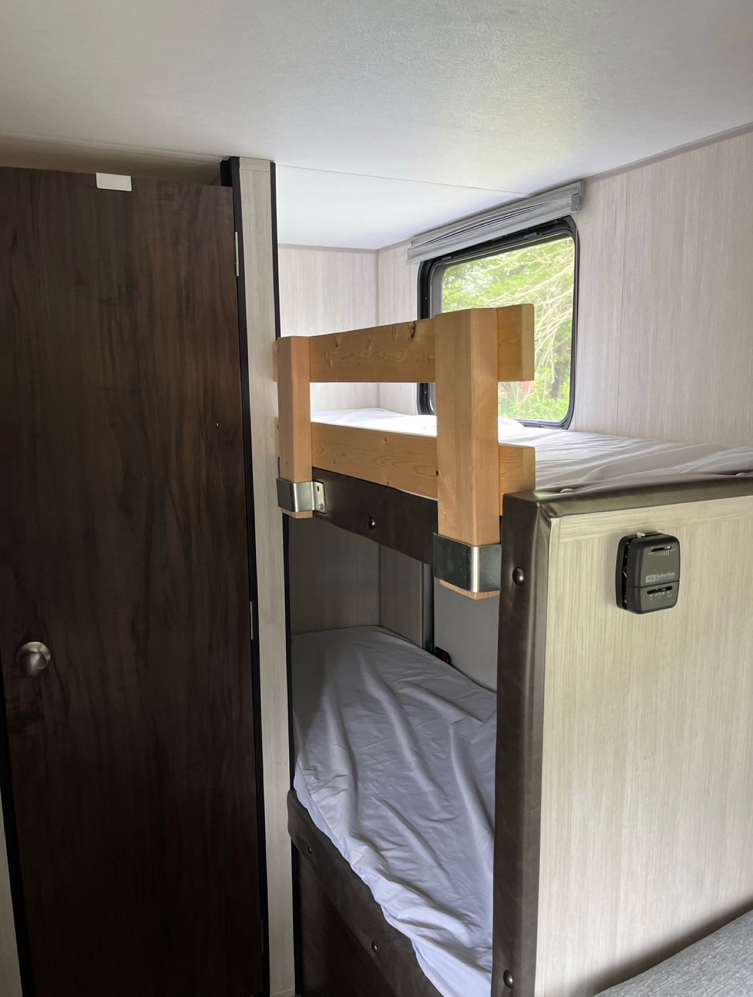 RV rental: View inside a compact sleeping area with two bunk beds (white sheets), a window, and a thermostat.. Forest River Cherokee Wolf Pup 2019