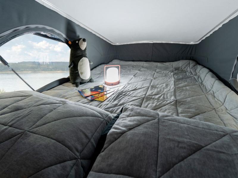 Sleeping for two on the second level pop top with a comfortable mattress, privacy, and views from windows on three sides. . Winnebago Solis 59P 2023