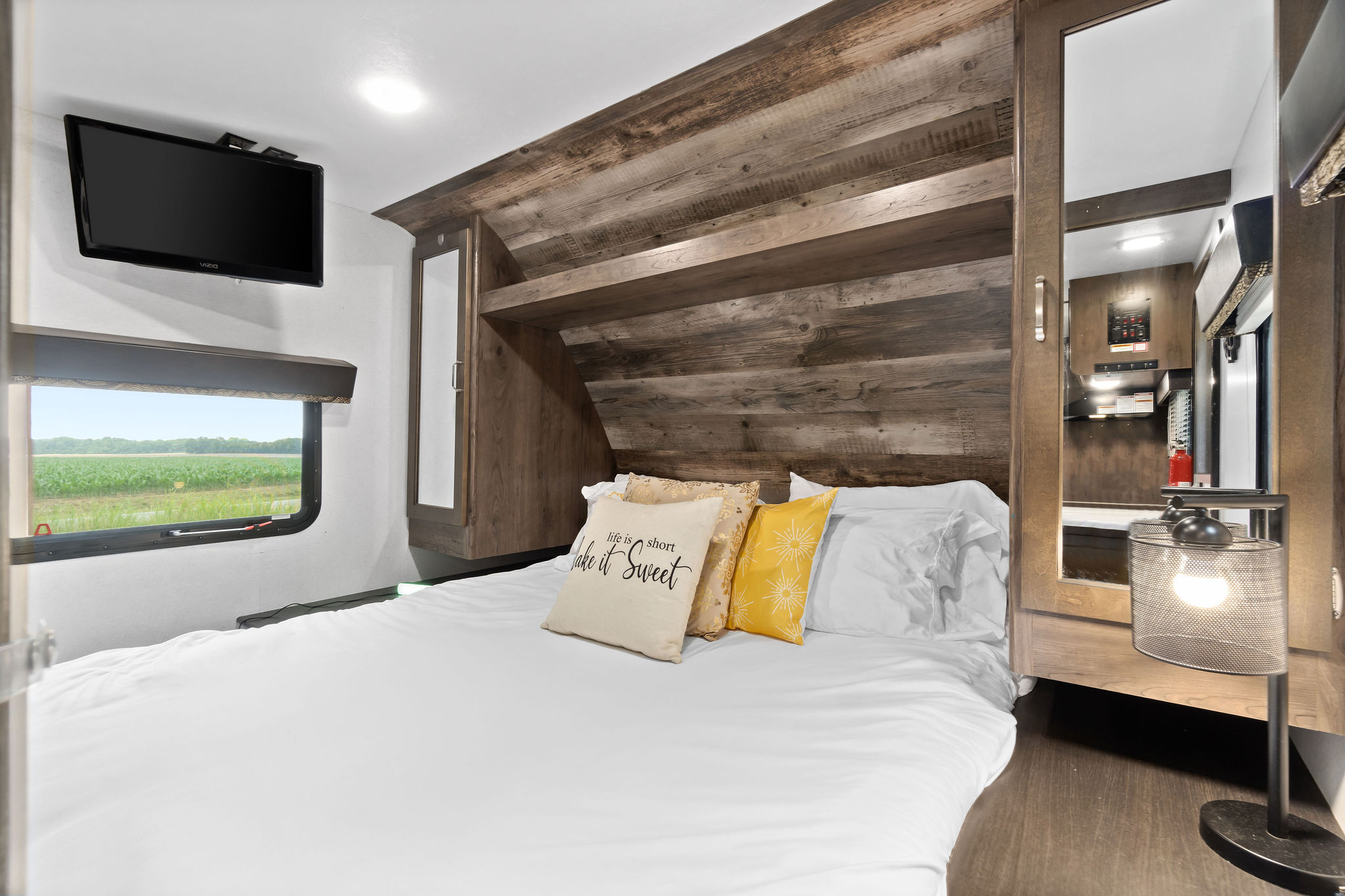 Right side of primary bedroom. Modern decor and cabinets.. Keystone RV Passport Grand Touring 2020