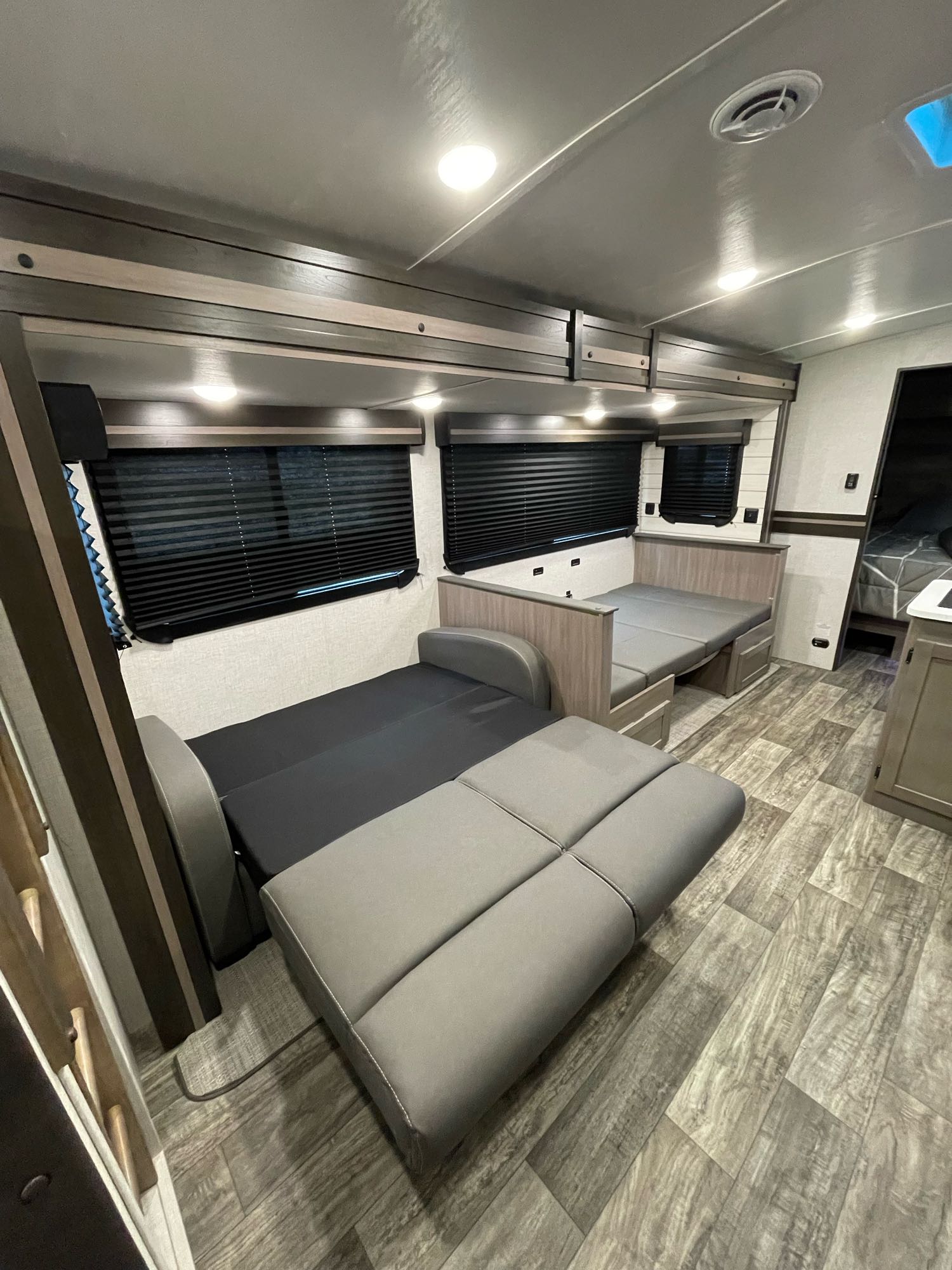 RV rental interior showcasing a comfortable living area with two convertible bed/dinette setups and modern finishes.. Crossroads RV Sunset Trail Super Lite 2022