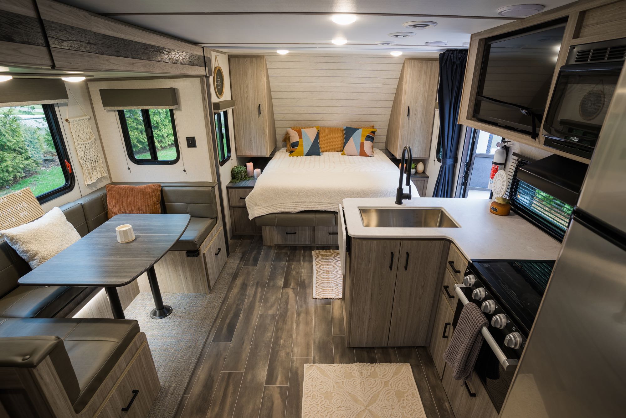 Your next RV rental adventure awaits! This cozy interior includes a comfortable bed, dinette, and a full kitchen for travel comfort.. Keystone RV Passport SL 2022
