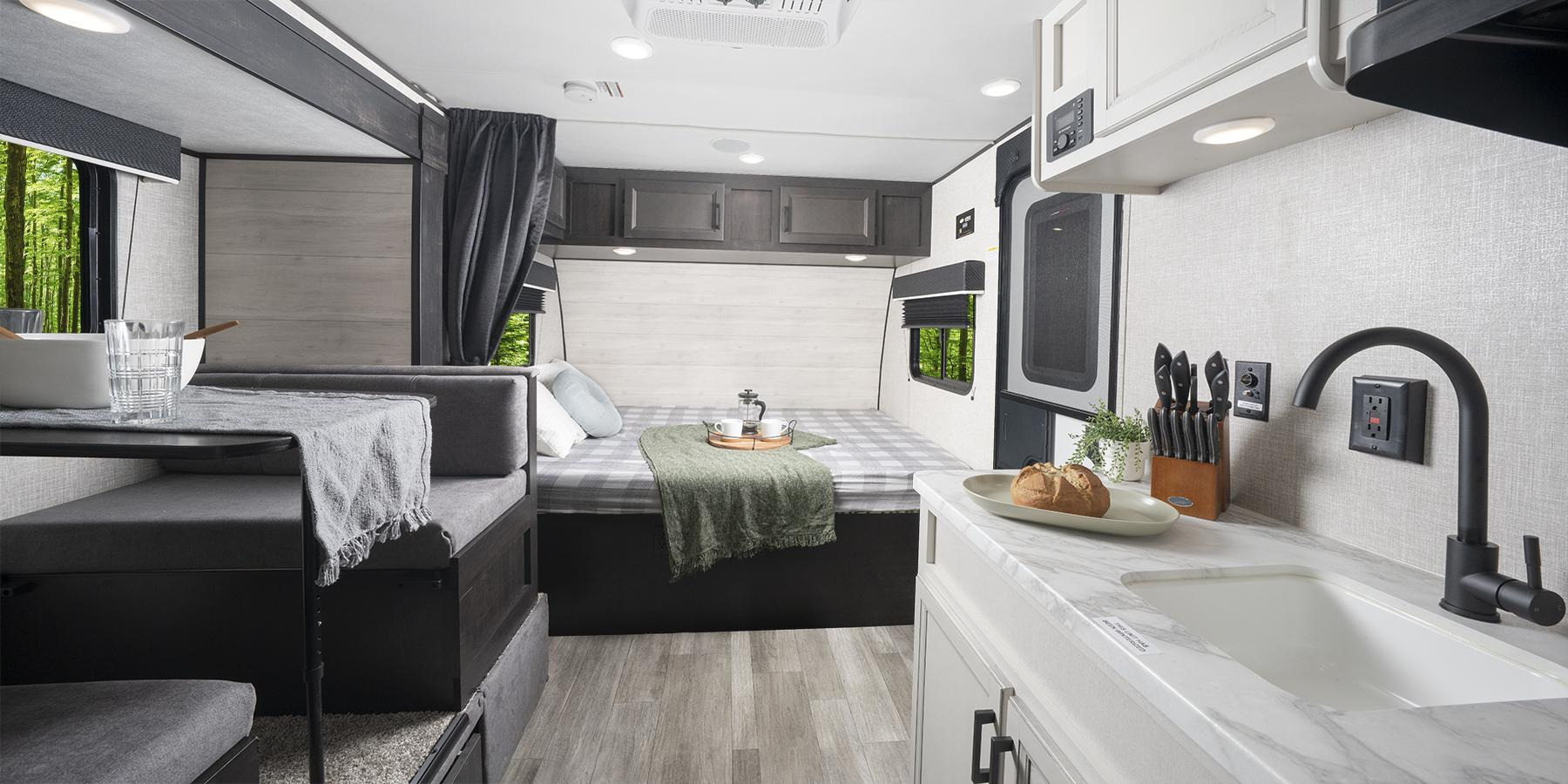 Explore a cozy rv rental with a functional kitchen, comfy bed, and dining nook. Enjoy mobile adventures!. Jayco slx 2023