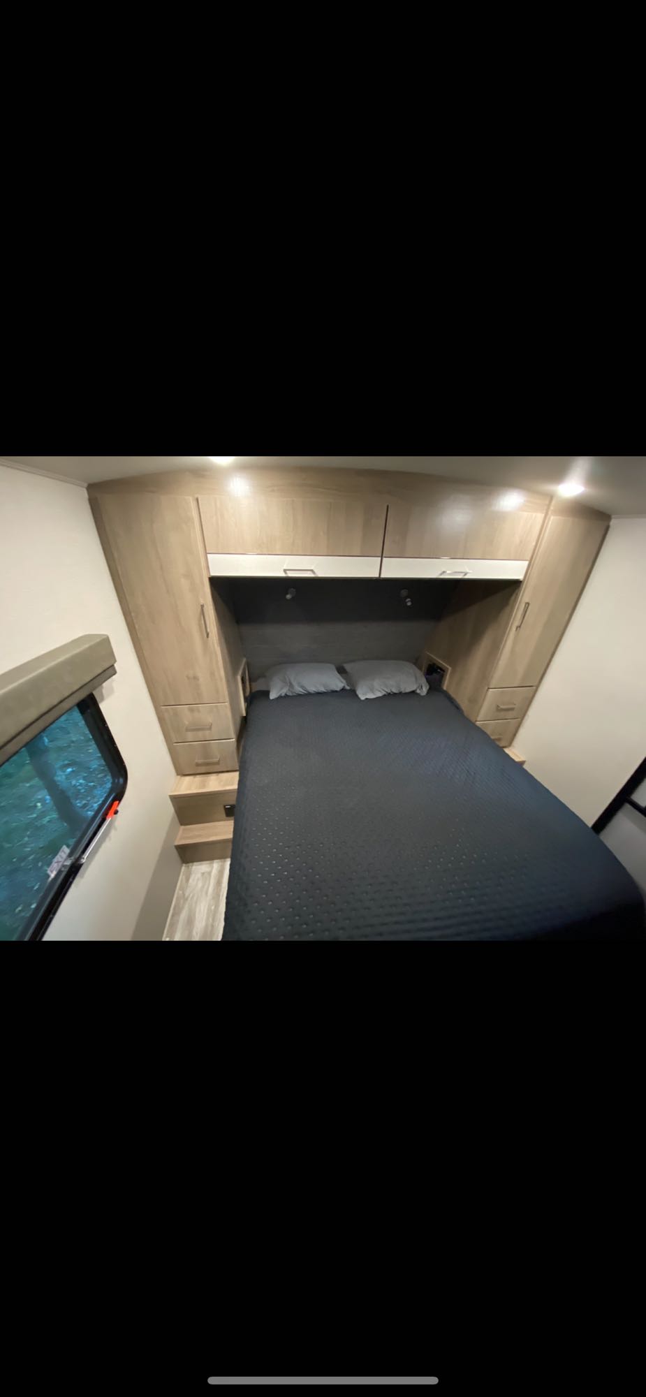 This RV rental features a comfortable queen bed, built-in storage, and a window, optimizing space for travel comfort.. Grand Design Imagine 2022