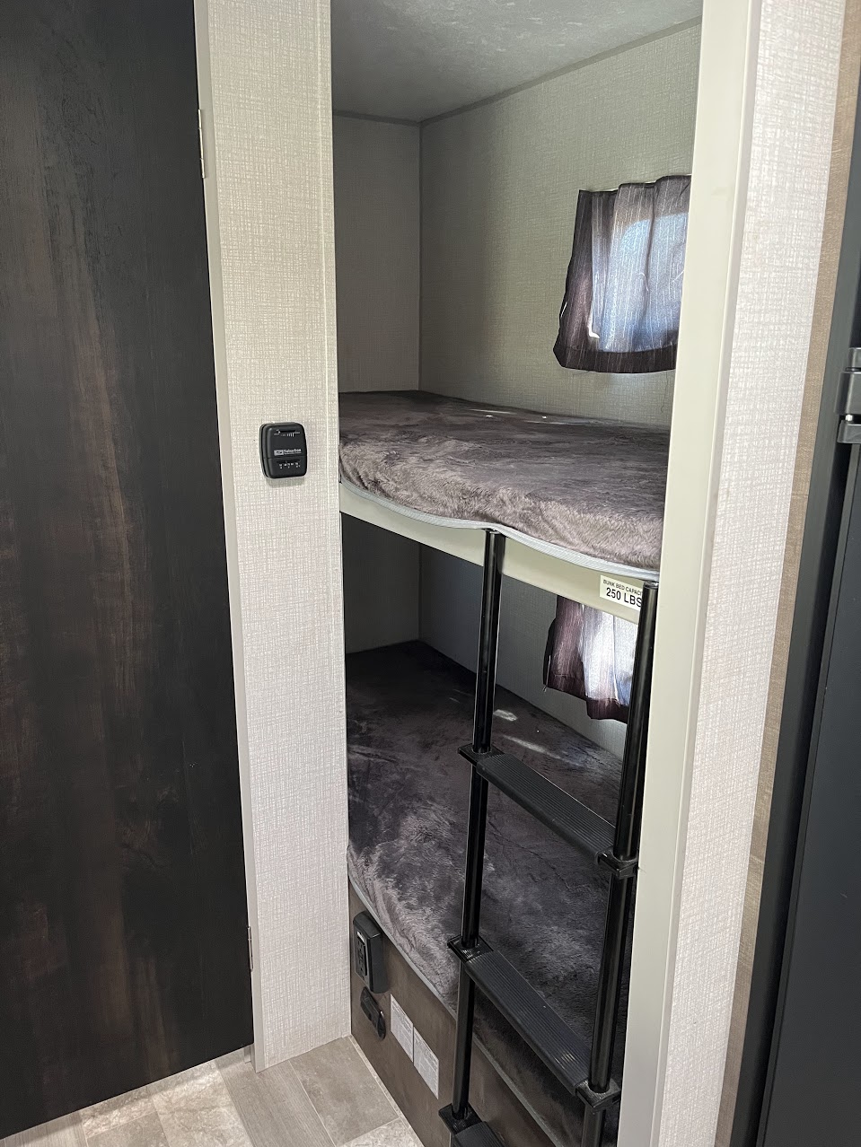 RV rental: Compact interior with two stacked bunk beds (250 lbs cap), ladder, soft blankets, and window.. Sportsmen Classic 2020