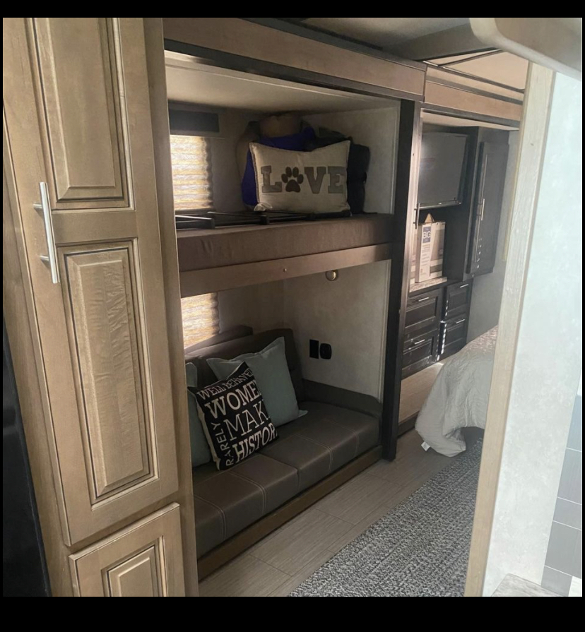 Explore this RV rental's spacious interior featuring cozy bunk beds, a comfy sofa, and a bedroom area.. FR3 FR3 Motorhome 2020