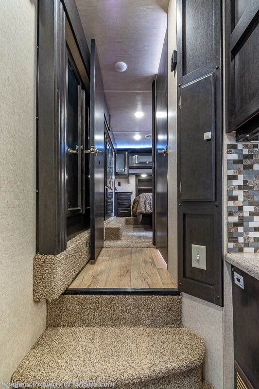 RV rental: Steps lead to a cozy hallway and bedroom area, showcasing the modern interior design.. Heartland RVs Road Warrior Toy Hauler 2017