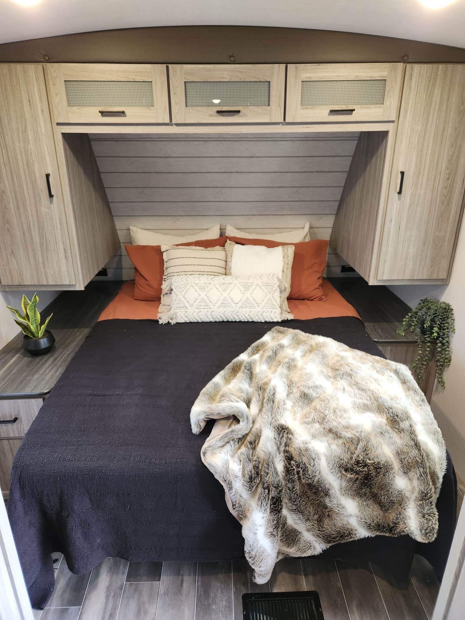 Plush bed and smart storage in this modern RV rental bedroom. Experience comfort on the road.. Keystone RV Passport GT 2022