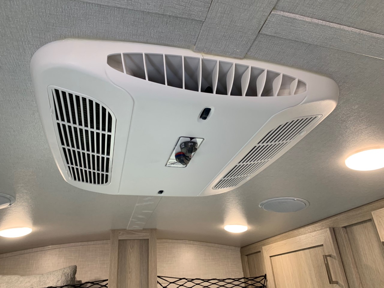 RV rental interior: White ceiling AC unit, lights, & speaker. Provides comfort on the road.. Forest River Flagstaff E-Pro 2022