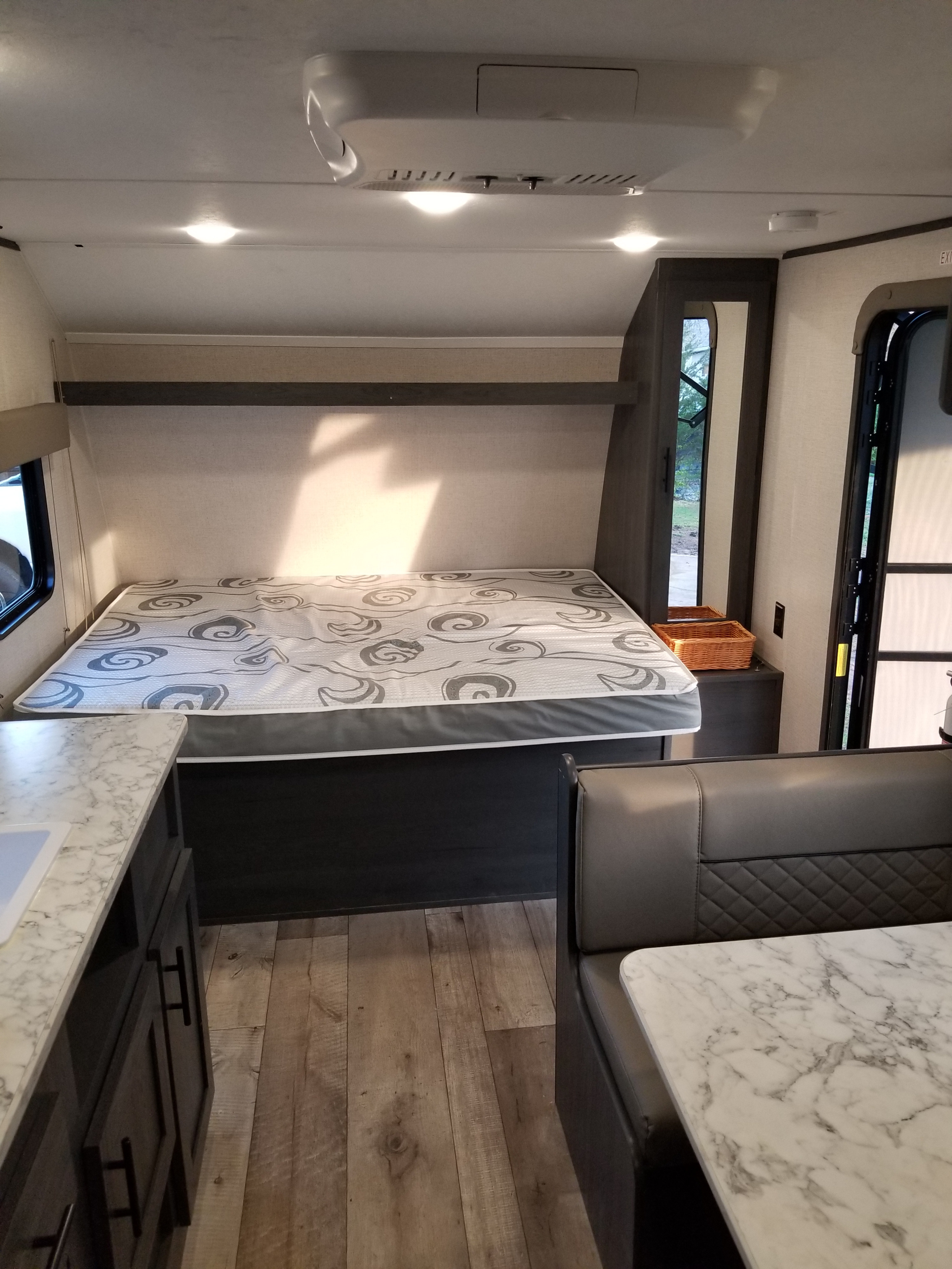 A well-appointed rv rental interior with a comfortable bed, dinette seating, and kitchen counter for your next adventure.. Aspen Trail LE 2022