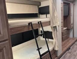 Cozy RV rental bunk beds: comfortable interior sleeping area for travel, complete with ladder and TV for your next adventure.. Jayco Precept Prestige 2021