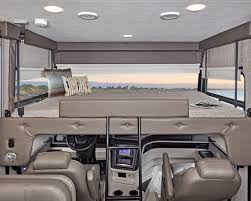 Spacious RV rental interior featuring a large cab-over bunk bed above the driver's cockpit. Perfect for family road trips.. Jayco Precept Prestige 2021