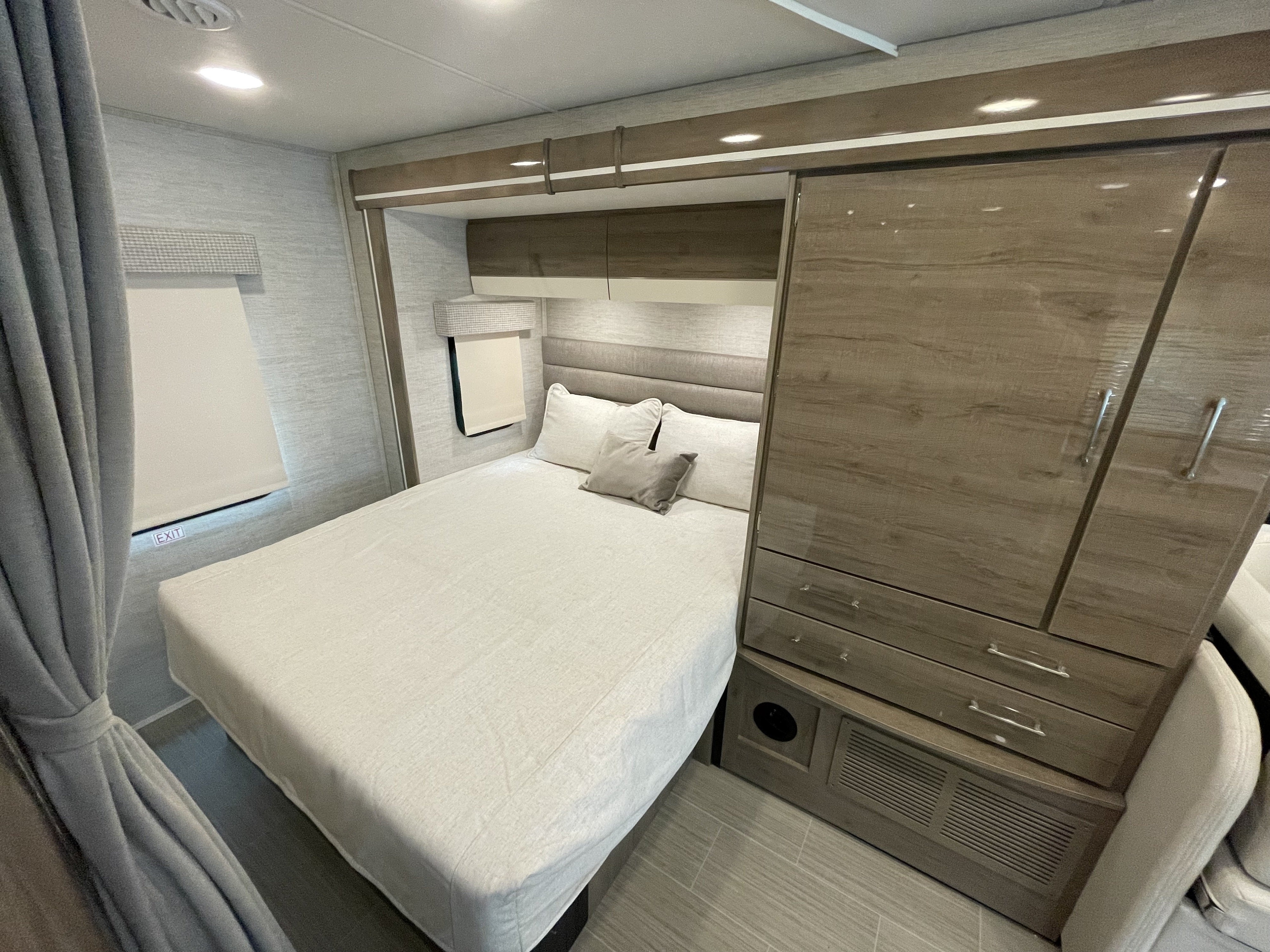 Comfortable RV rental bedroom featuring a bed, wardrobe, and overhead storage in a modern motorhome interior.. Jayco Melbourne 2022
