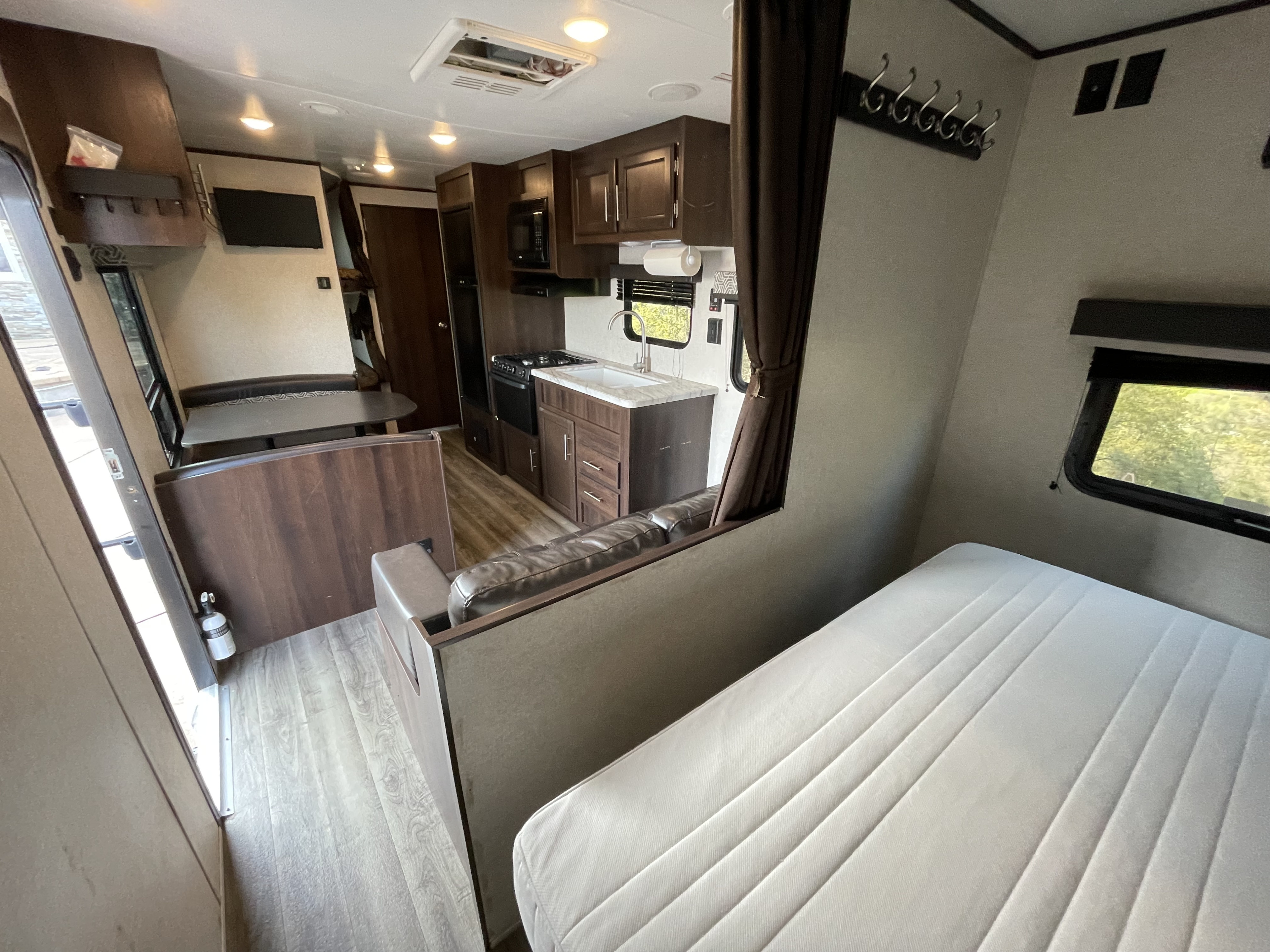 Spacious rv rental interior showing a kitchen, dining, living areas, and a comfortable bed.. Jayco Jay Flight SLX Baja Edition 2019