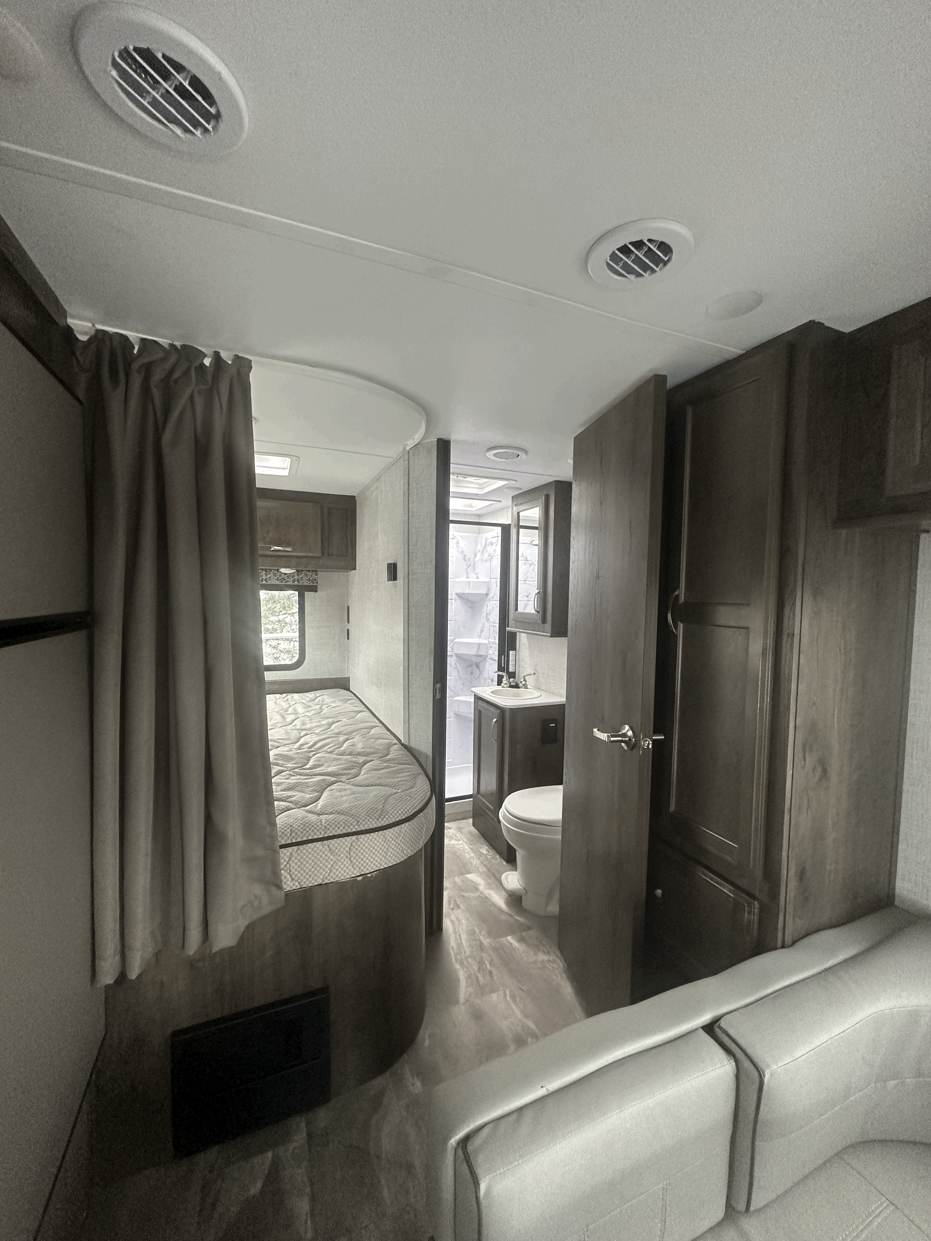 Explore this RV rental's clever interior: a comfy bed, functional bathroom, and living space. Ideal for your next trip!. Gulf Stream Conquest 2022