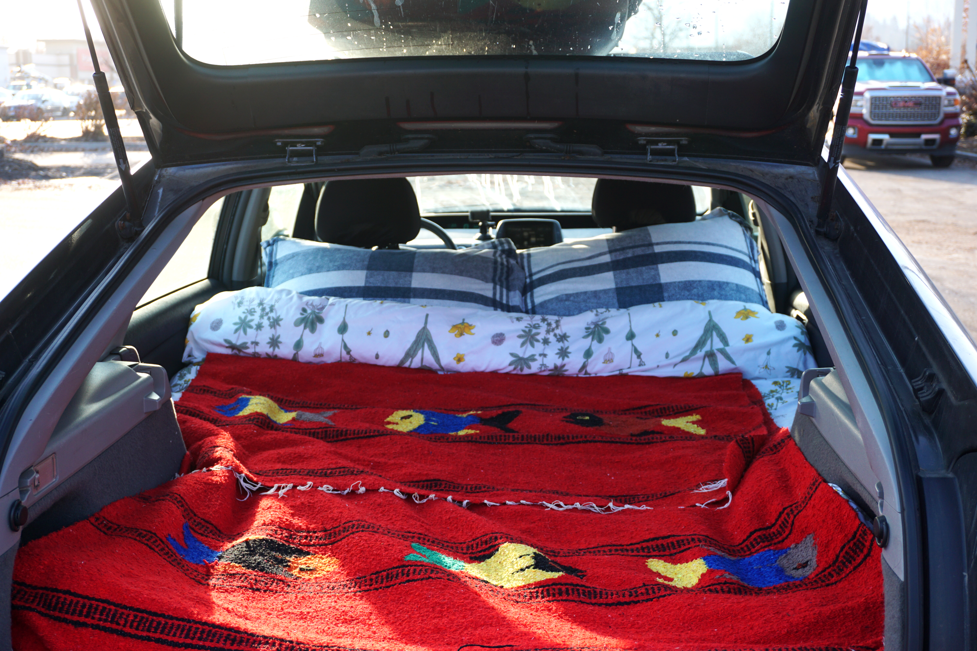 Cozy car camping bed in a hatchback, a practical alternative to RV rental.. toyota Prius 2007