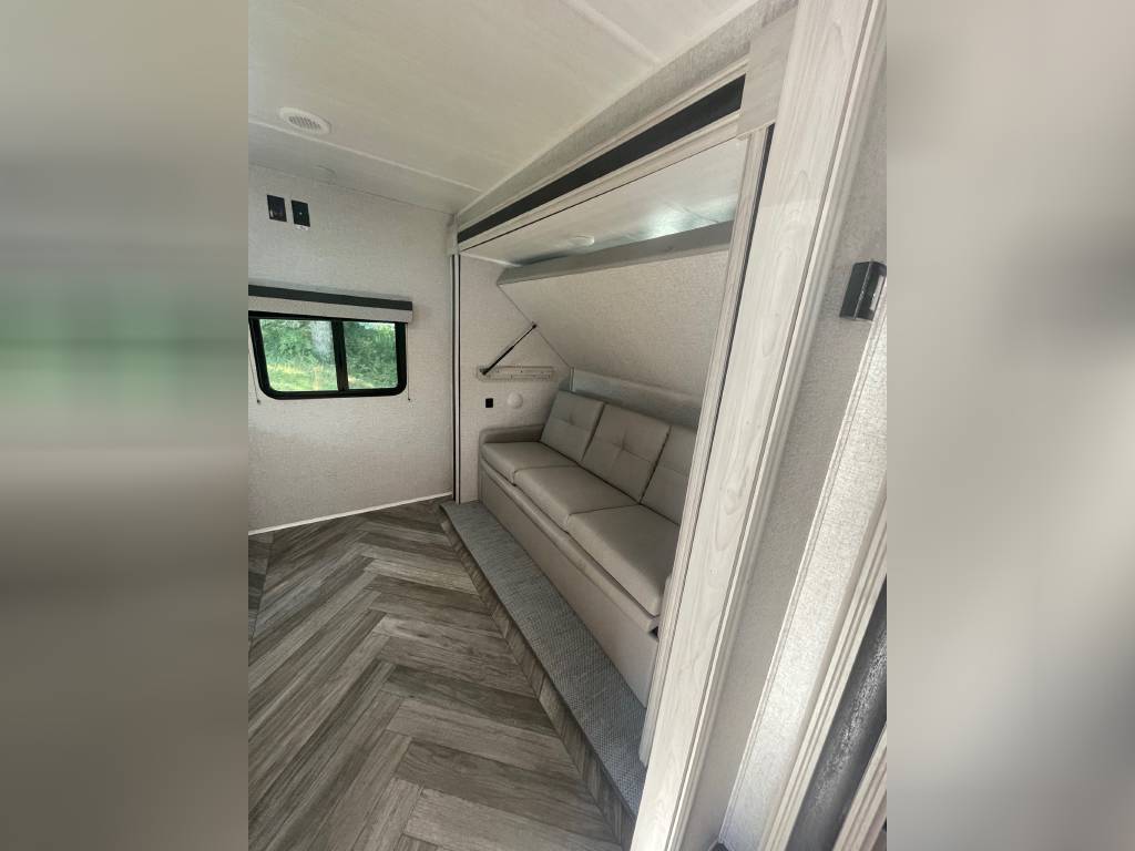 Bunkhouse sofa sleeper and top bunk. East to West Della Terra 2022