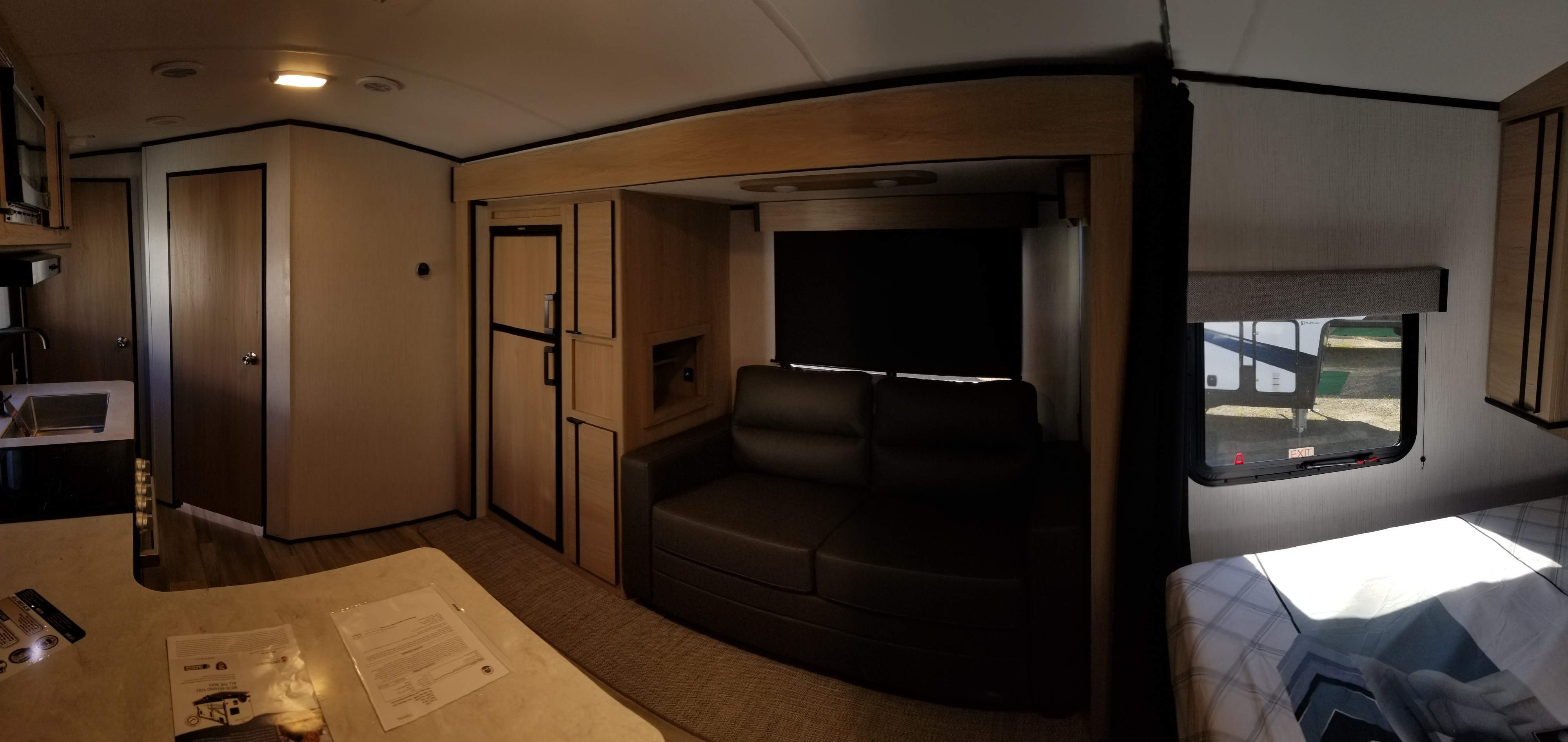 **RV rental** interior: a functional and comfortable space with a kitchen, fridge, sofa, and bed.. Cruiser Rv Corp Radiance 2022