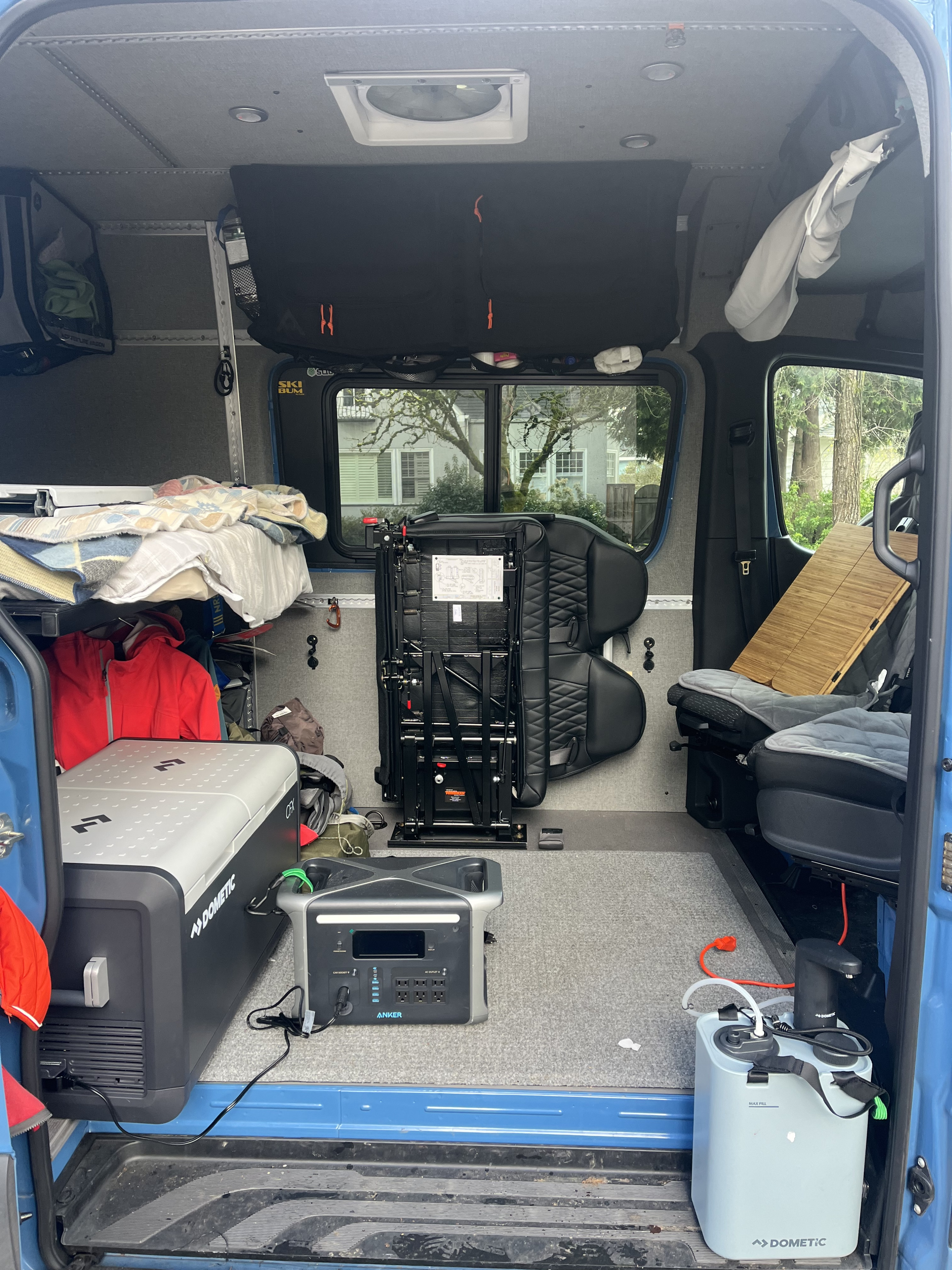 RV rental interior: a fully equipped camper van with bed, portable power, fridge, and sink.. Mercedes-Benz Sprinter 2021