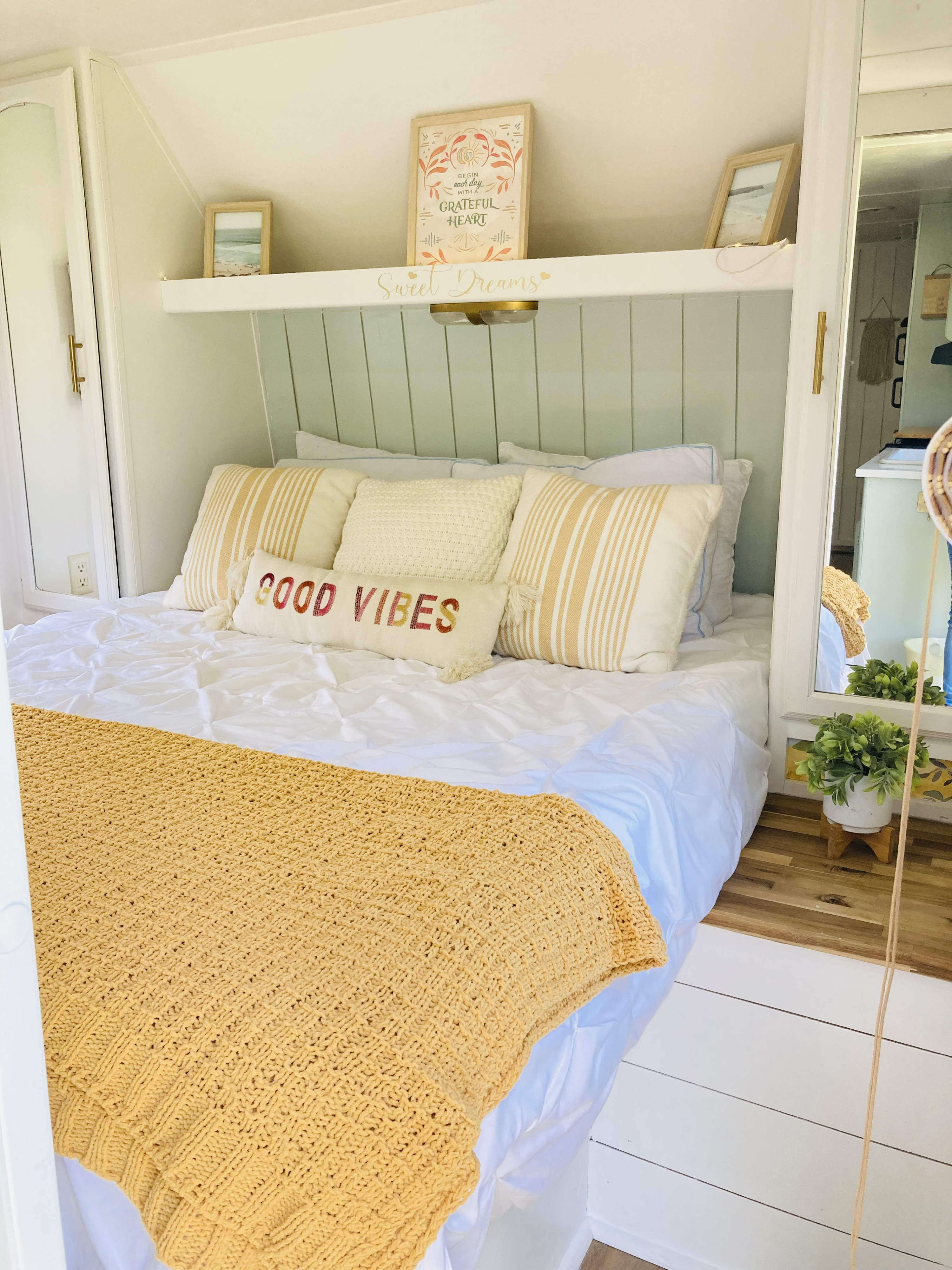 Experience comfort in this cozy rv rental bedroom, featuring white bedding, a yellow throw, and good vibes decor.. Other Other 2013