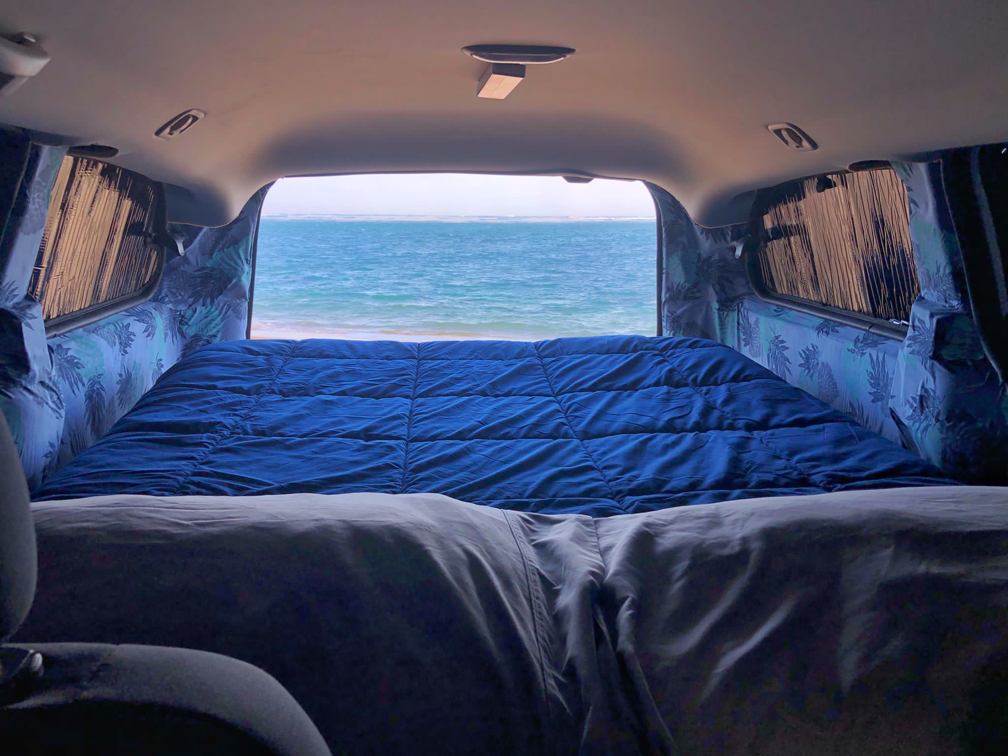 Cozy RV rental with a comfy bed and serene ocean view. Ideal for beach adventures and van life camping!. Dodge Grand Caravan 2010