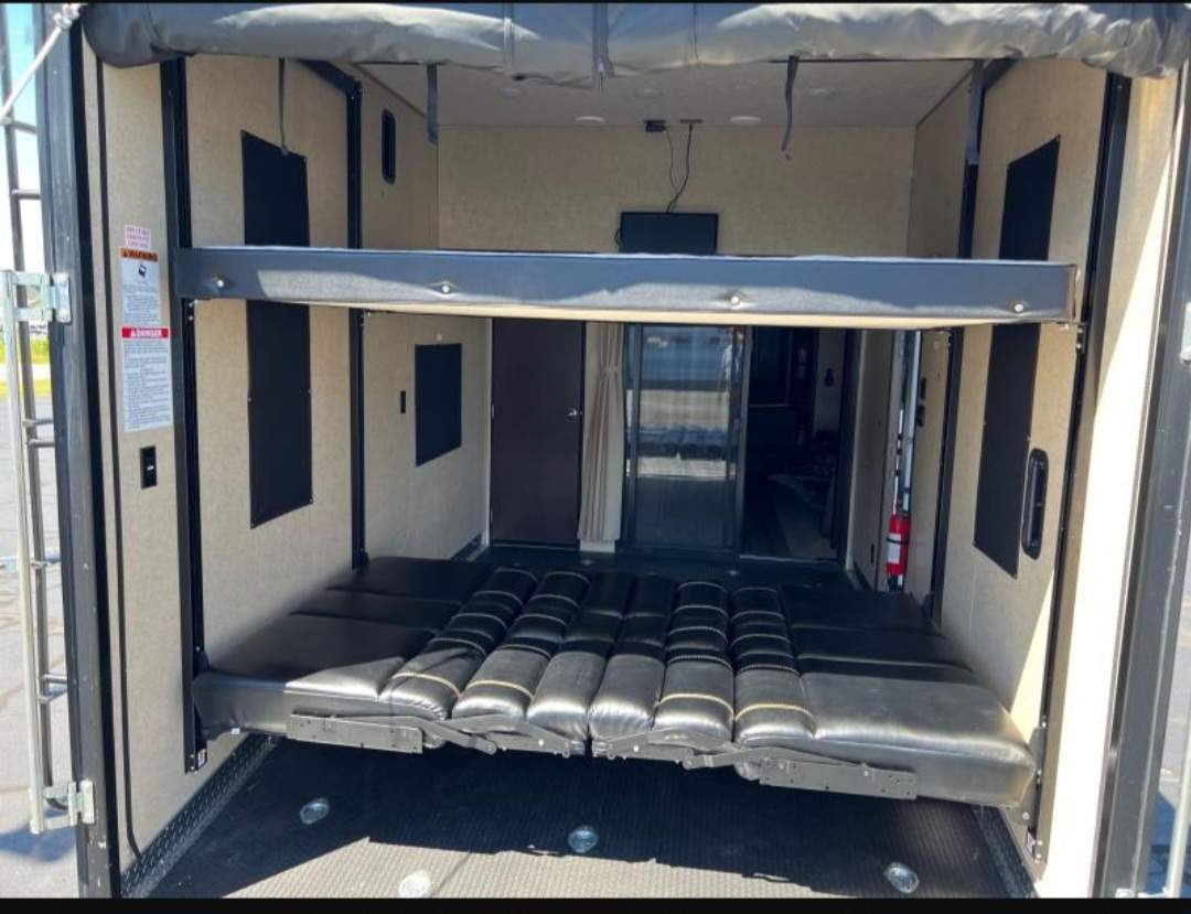 RV rental: Toy hauler interior showcasing adjustable beds/seating in the rear garage. Versatile space.. Forest River Cherokee Wolf Pack Toy Hauler 2018