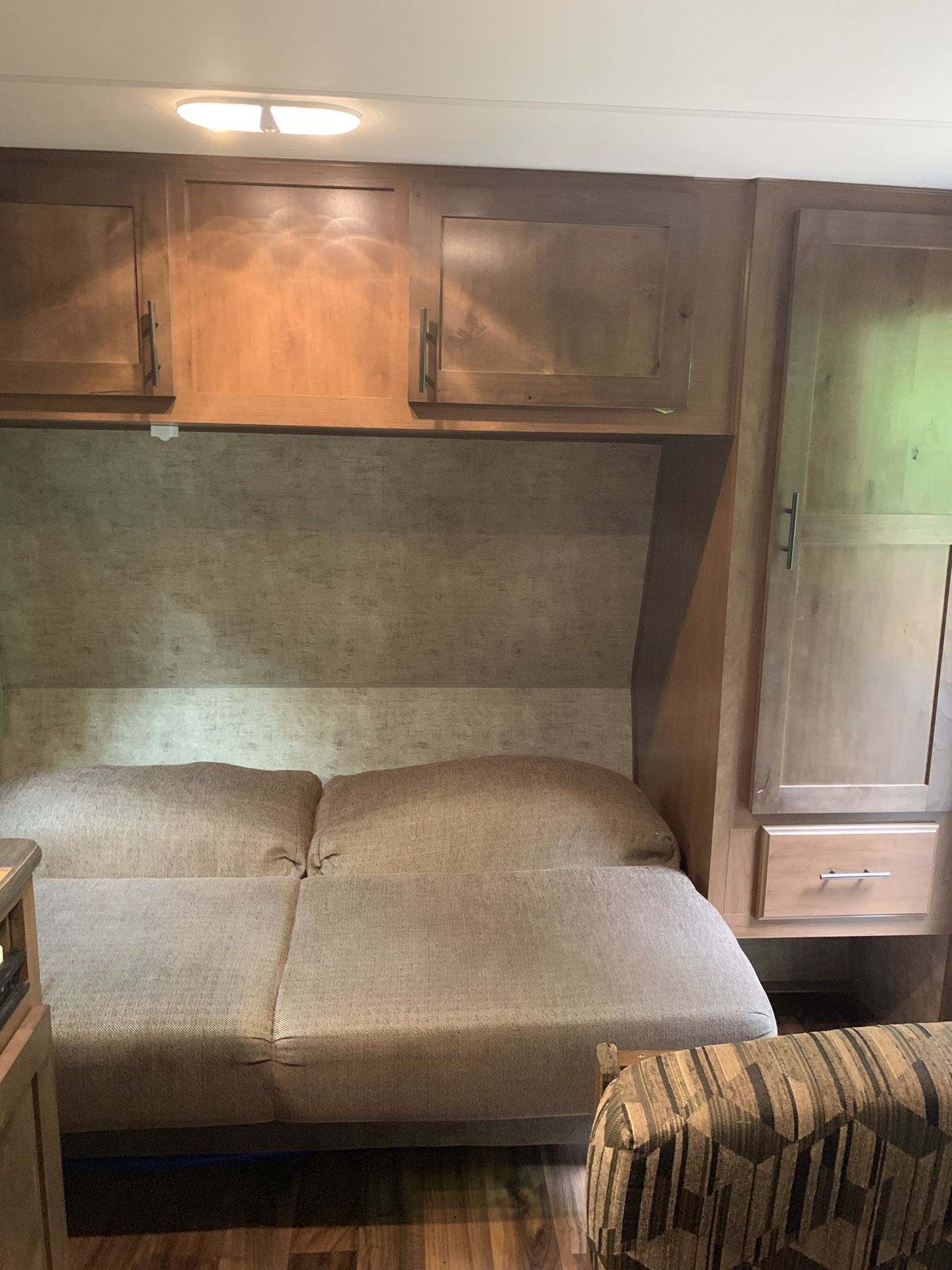 RV rental: Interior featuring a comfortable sofa/bed with overhead wooden cabinets and a wardrobe for storage.. Outdoors RV Blackrock 2017