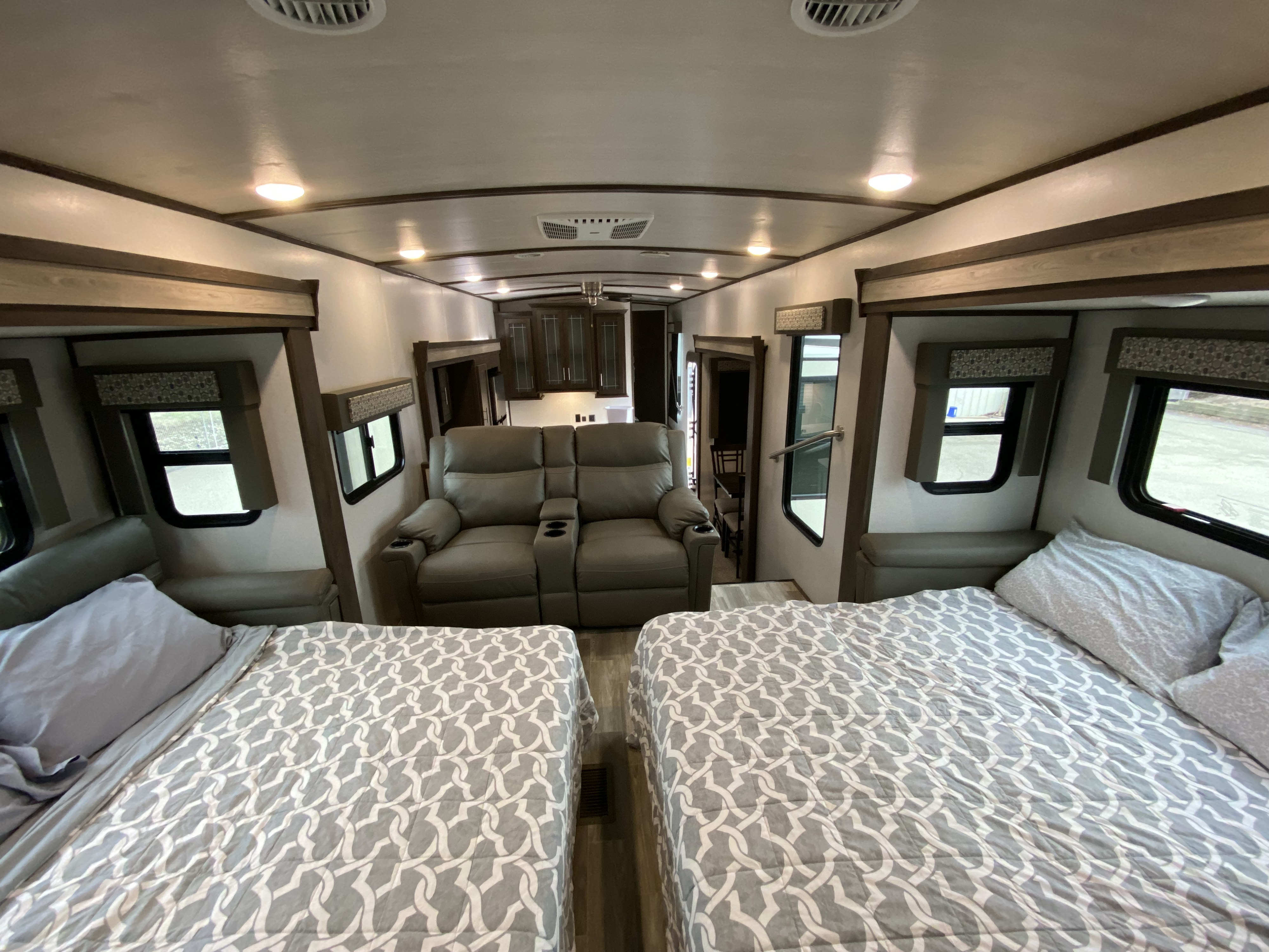 Spacious RV interior: two beds, a comfy recliner, and a kitchen area, perfect for your RV rental.. Forest River Salem Hemisphere 2020
