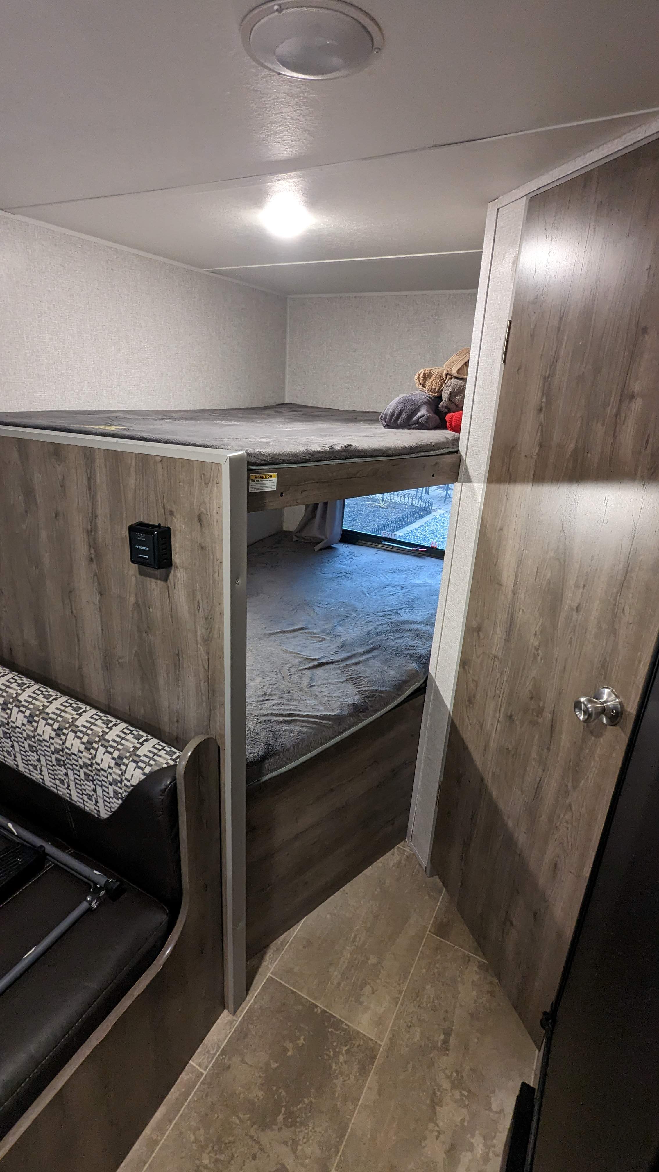 Inside an RV rental featuring comfortable bunk beds and a modern interior, perfect for family travel and adventures.. Aspen Trail LE 2020