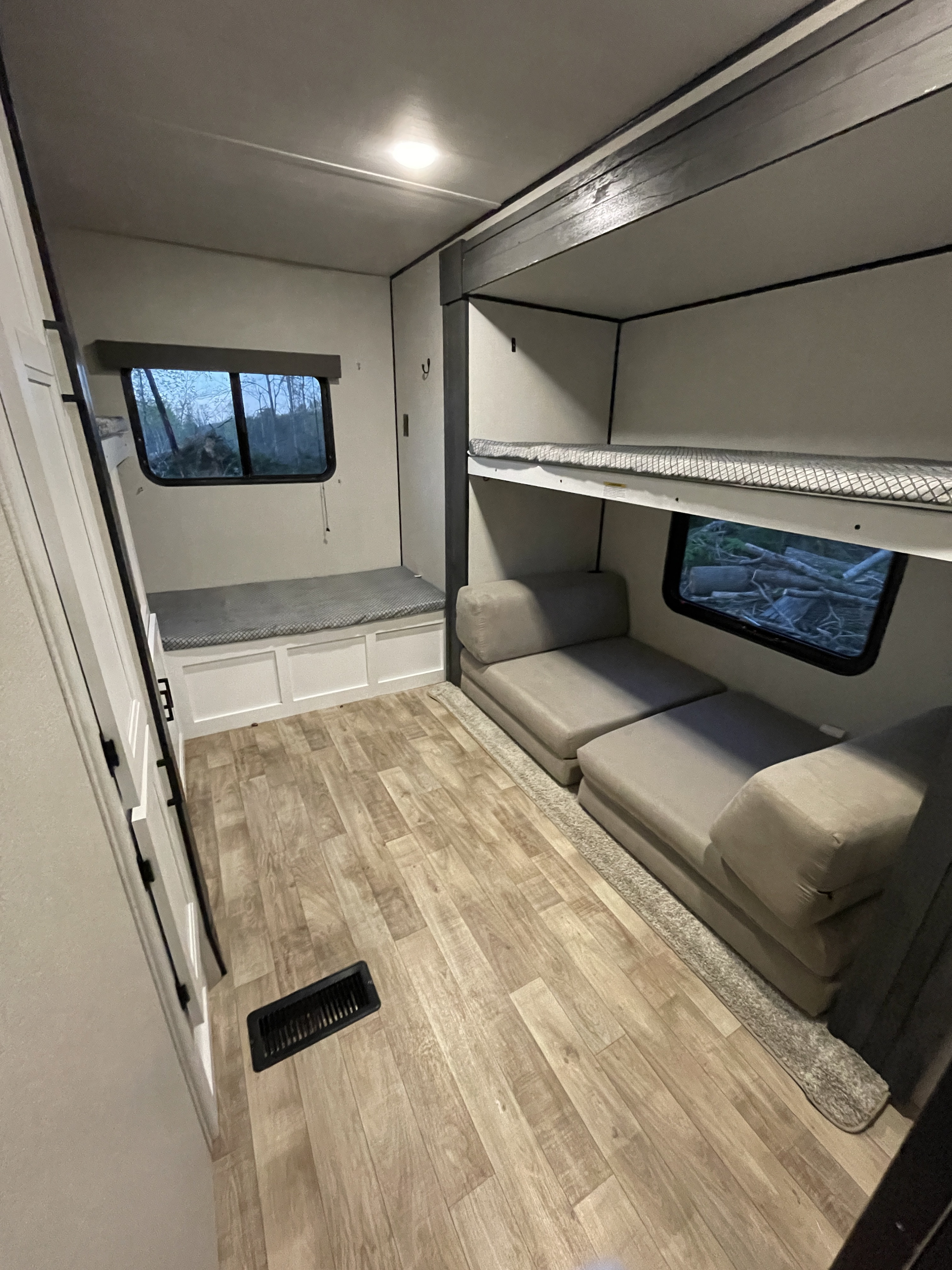 Spacious RV rental bunkhouse features convertible modular sofa, cozy bunk beds, and bench storage.. Keystone RV Hideout 2022