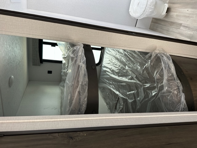 Inside an RV rental: New, plastic-wrapped mattresses for bunks or storage areas, ready for your trip.. Coachmen Clipper 182DBU 2022