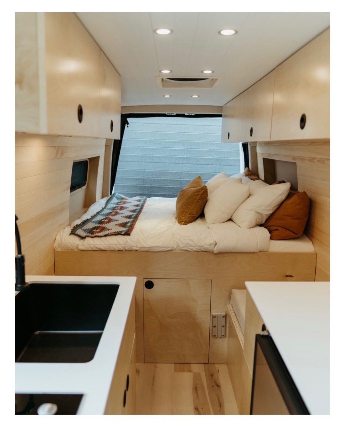 The main queen size bed with plenty of storage above. *Bedding style/colors may be different from pictured*. Mercedes Sprinter 2019