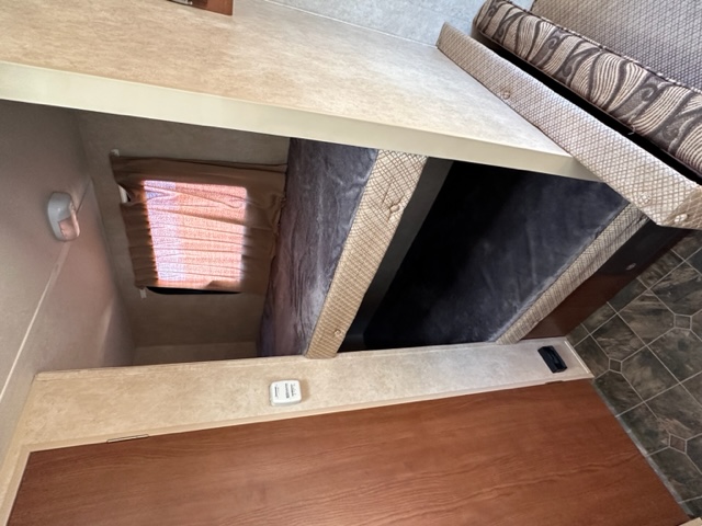 RV rental: Interior shows a lower bunk with a window and light fixture, plus adjacent patterned seating. Great for camping!. Salem Cruise Lite 195BH 2014