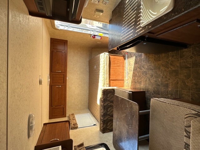 RV rental interior: A bright, functional space with a compact kitchen, sleeping area, and storage cabinets for travel.. Salem Cruise Lite 195BH 2014