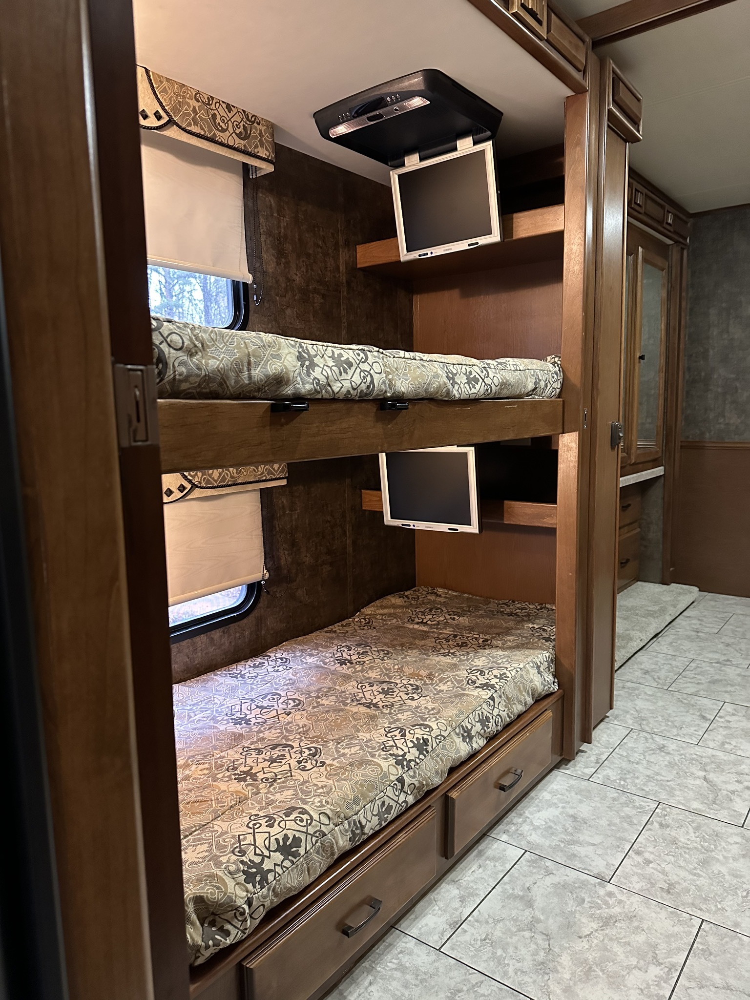 Well-equipped RV rental: cozy bunk beds with TVs, windows, and under-bed storage drawers for family trips.. Allegro Allegro Motorhome 2012