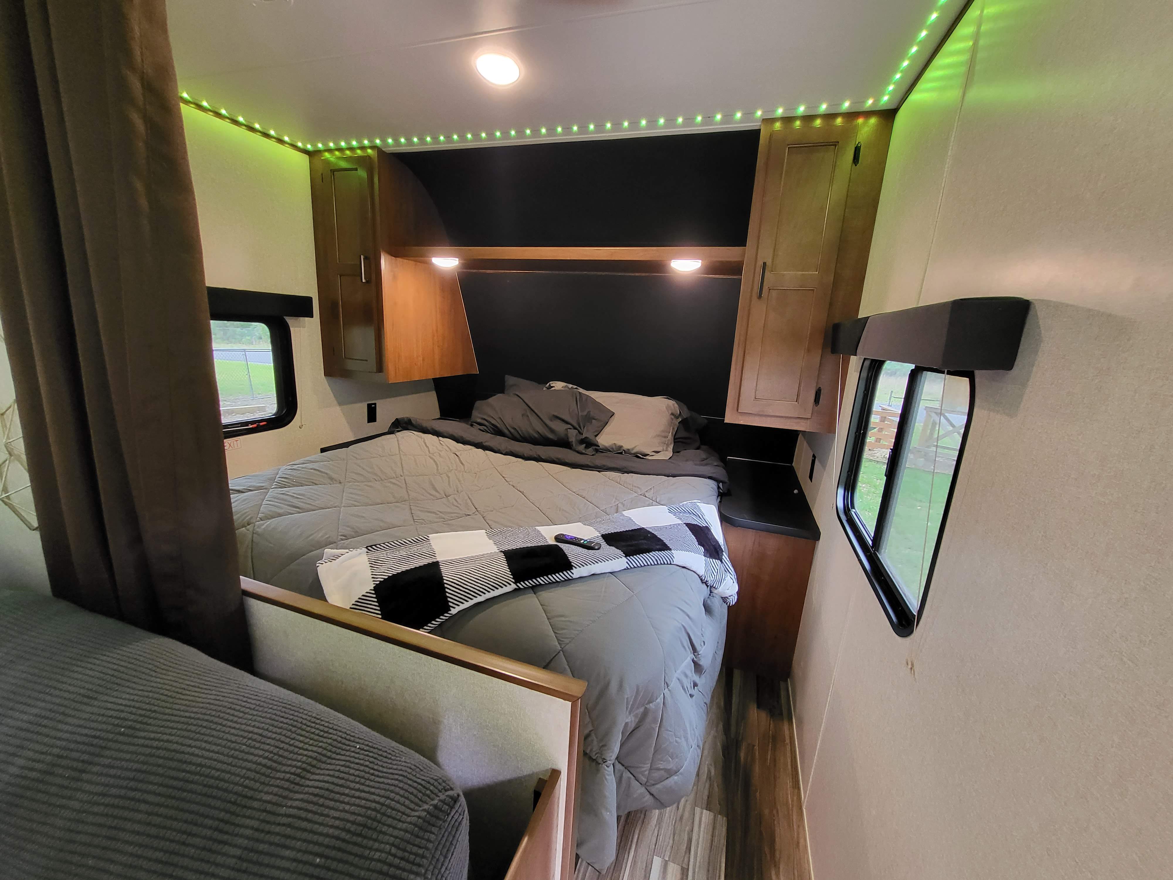 Cozy RV rental bedroom with green LED lights, a comfortable bed, and wood accents. Perfect for a relaxing getaway.. Jayco Jay Flight SLX 2017