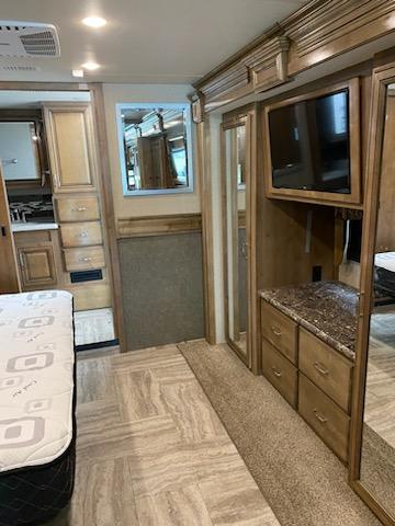 Step inside this cozy RV rental! Features a bedroom, living area with TV, ample wood cabinetry, and a bright interior.. Holiday Rambler Navigator 2019