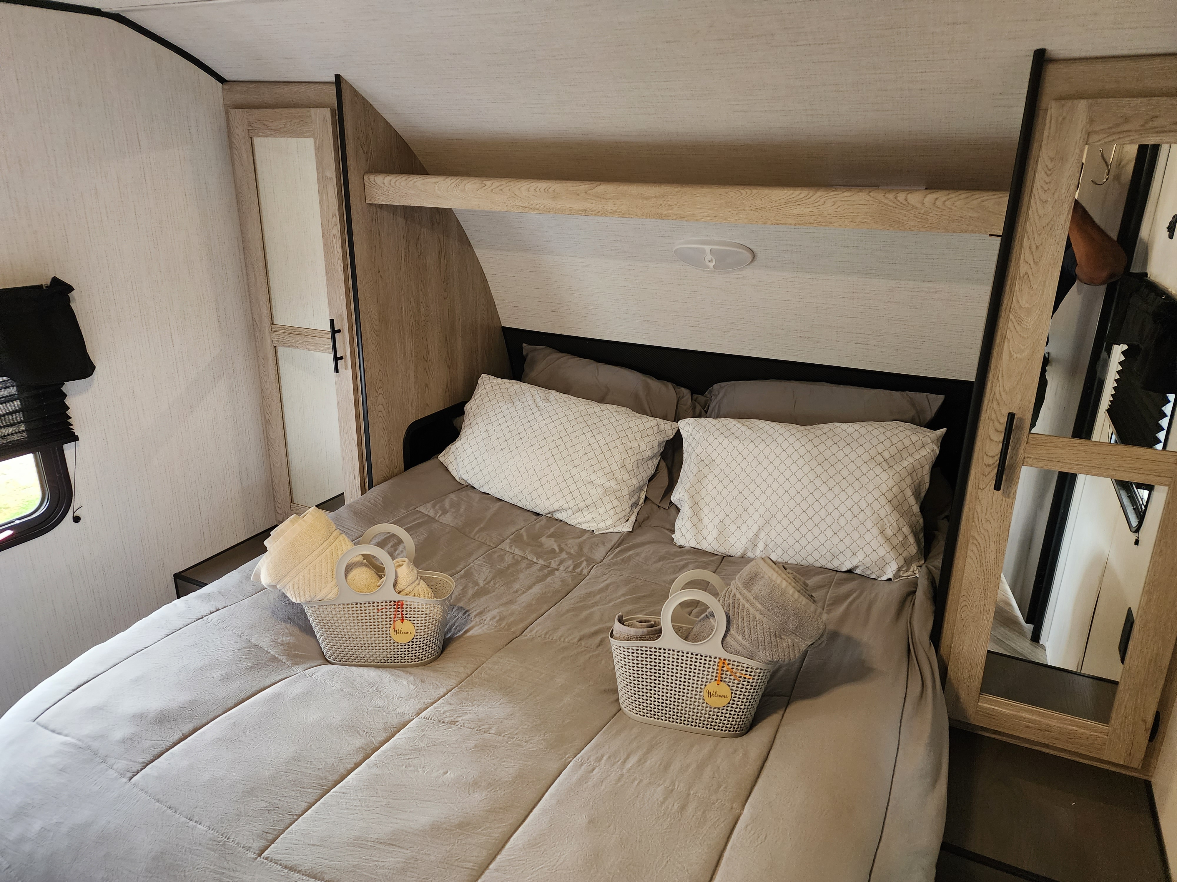 Cozy RV rental bedroom with queen bed, inviting welcome baskets, and smart built-in storage.. Heartland RVs Prowler 2022