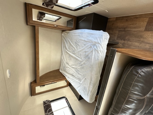 This RV rental offers a compact, modern interior with a bed, mirrored cabinet, and comfortable seating.. Salem Cruise Lite 261BHXL 2018