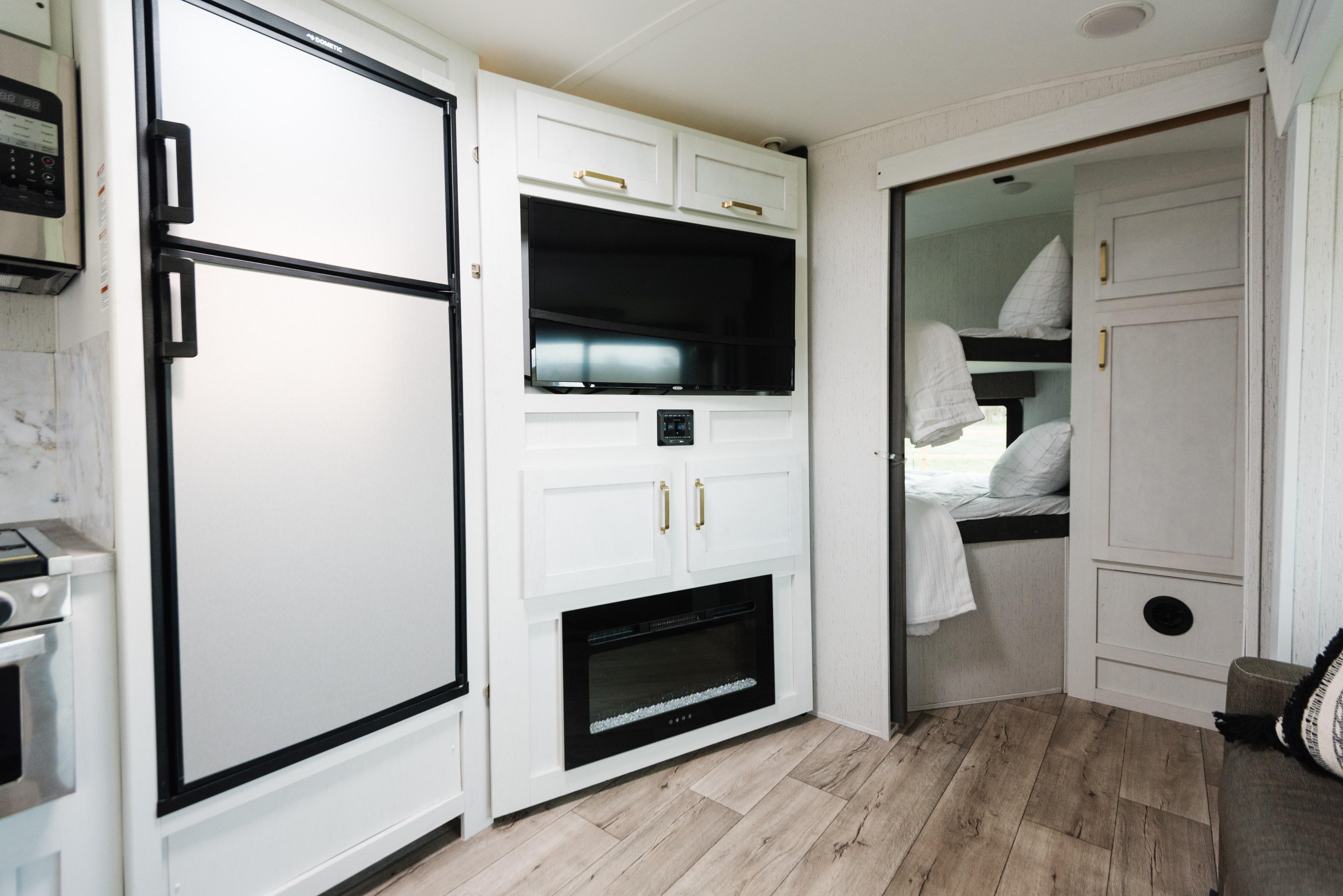 Tour this rv rental's modern interior: a sleek kitchen, entertainment center with a TV & fireplace, and comfy bunk beds.. Dutchmen Astoria 2022