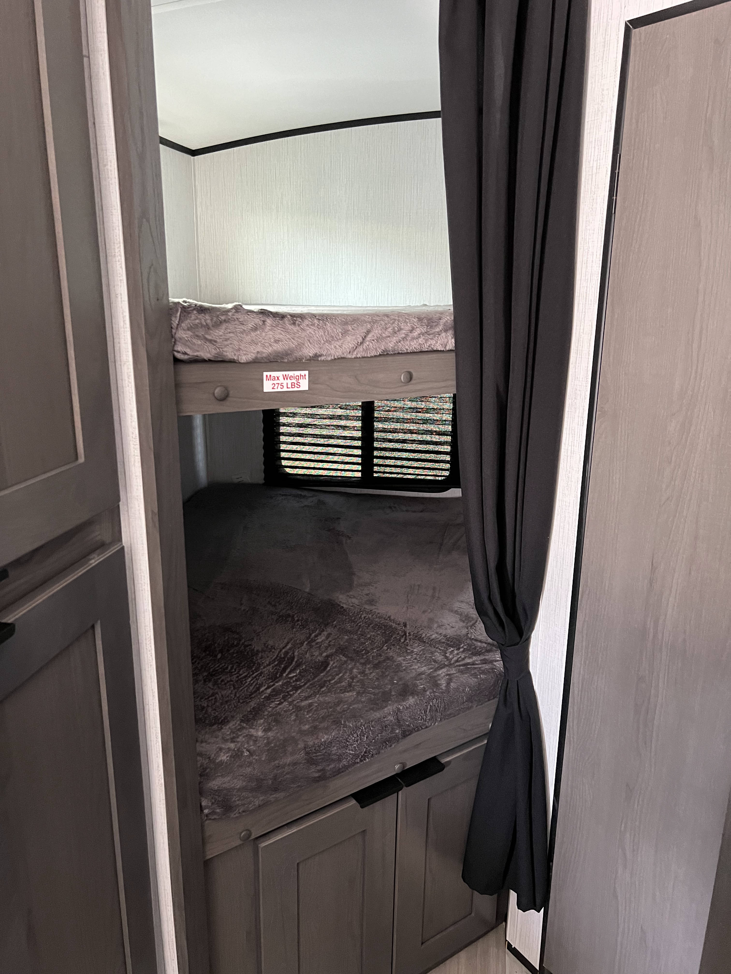RV rental interior: two bunk beds with a max 275 lbs top bunk limit, window, and storage. Ideal for camper trips.. Cruiser RV MPG Ultra Lite 2022