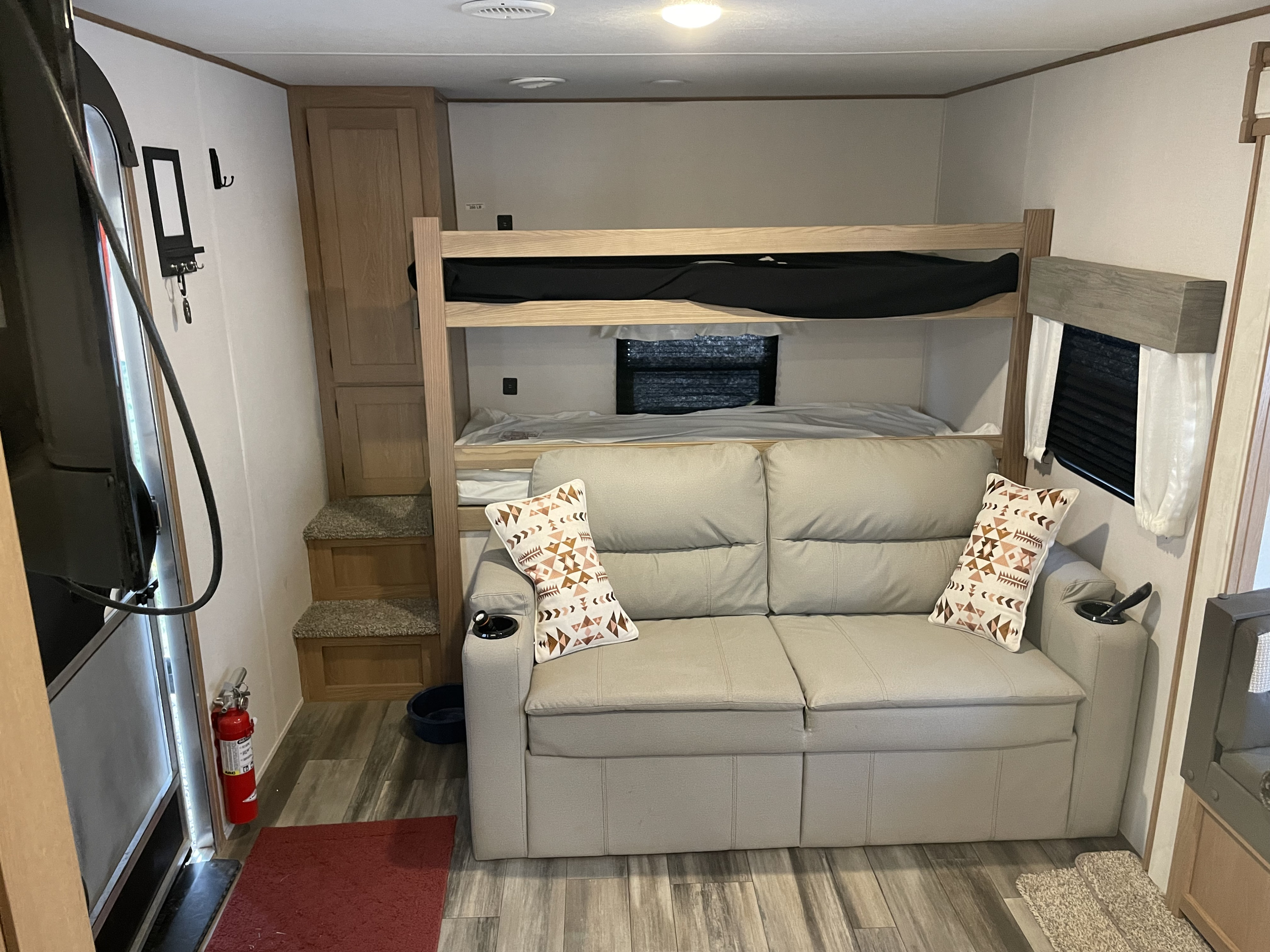 RV rental: Bunk beds and a gray sofa create a cozy sleeping and living space, with built-in storage and safety features.. Avenger Avenger Trailer 2022