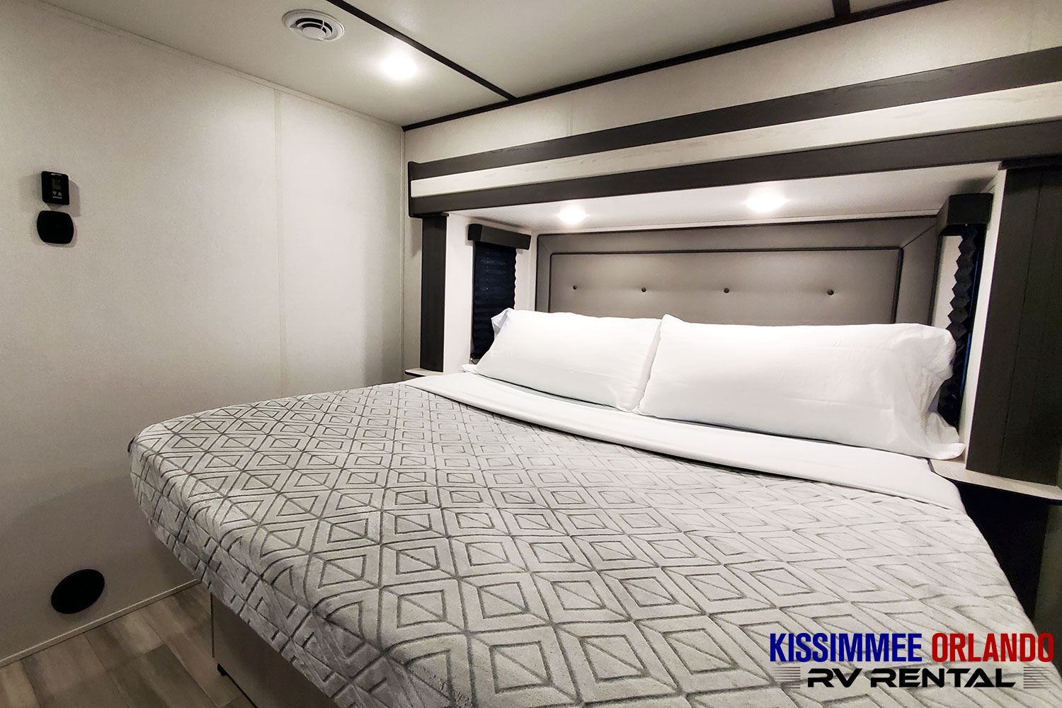 Spacious, modern RV bedroom interior. Enjoy comfortable nights on your RV rental adventure in this cozy space.. Keystone Sprinter 2023