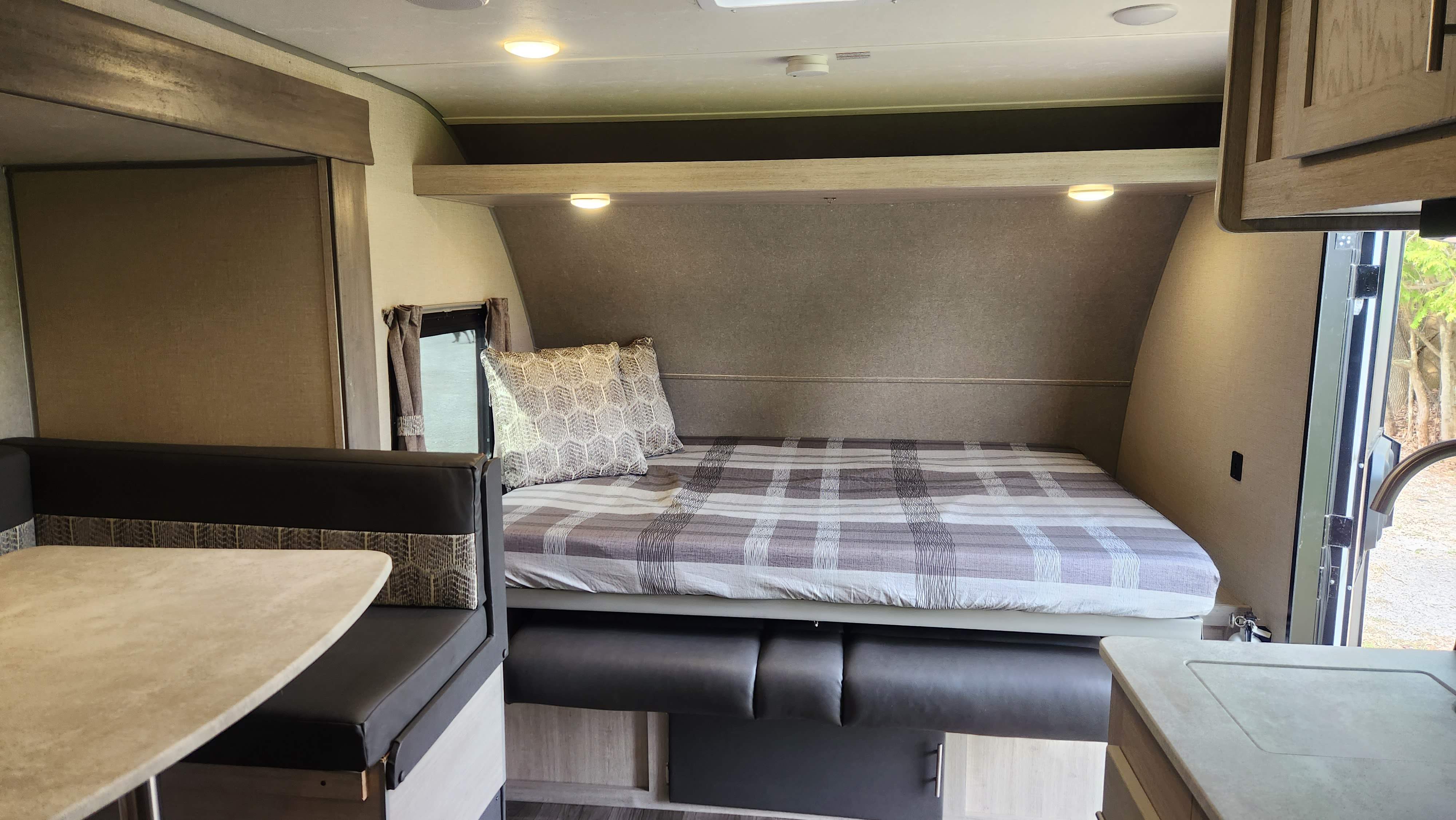 Clean RV rental interior: comfy bed, dinette, bright lights. Perfect for your next adventure.. Coachmen Catalina Summit 2022