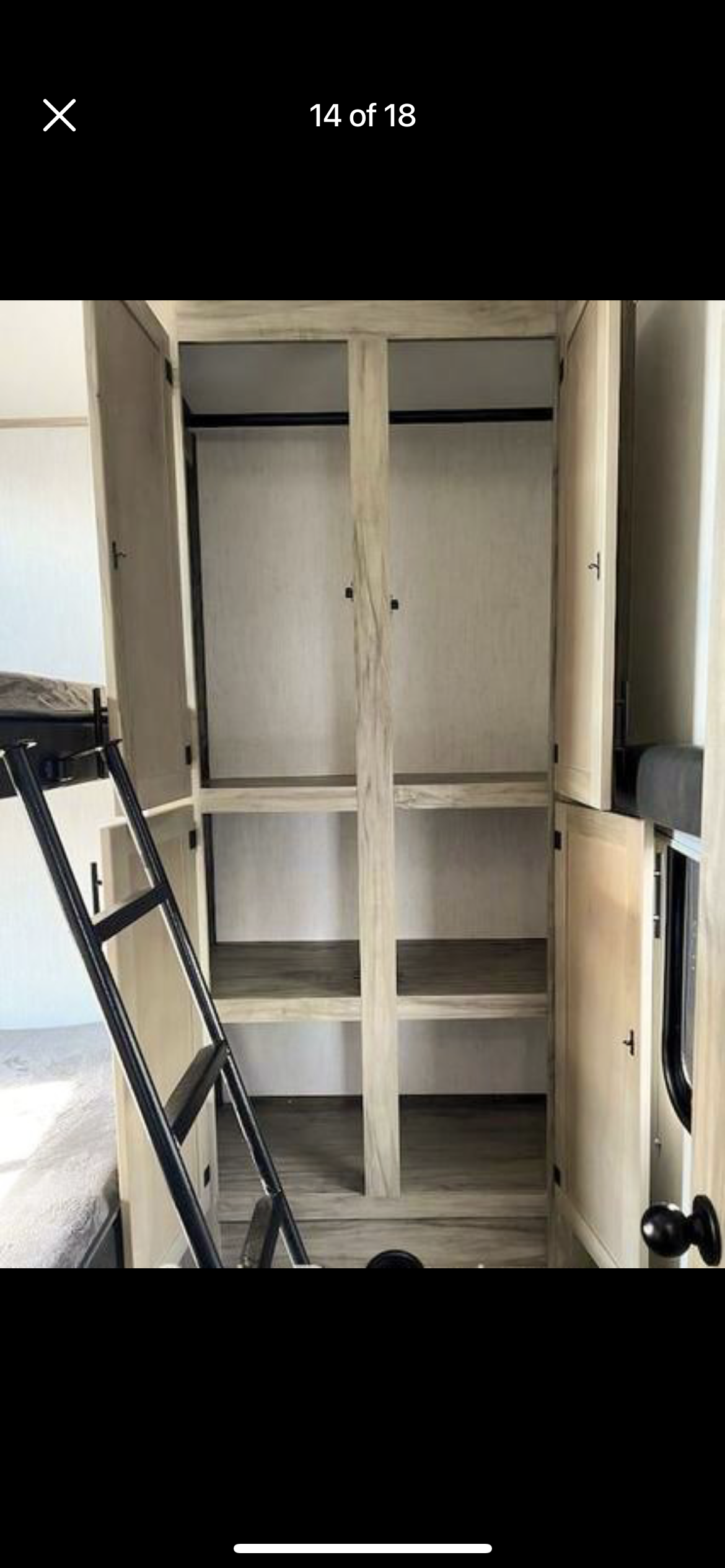 RV rental: Interior with bunk beds, ladder, and light wood wardrobe offering ample shelving and a hanging rod.. Forest River Cherokee Arctic Wolf 2021