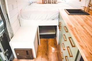 Step inside this cozy RV rental: a modern van conversion with a comfy bed and functional kitchen.. Ford Custom Transit 2019