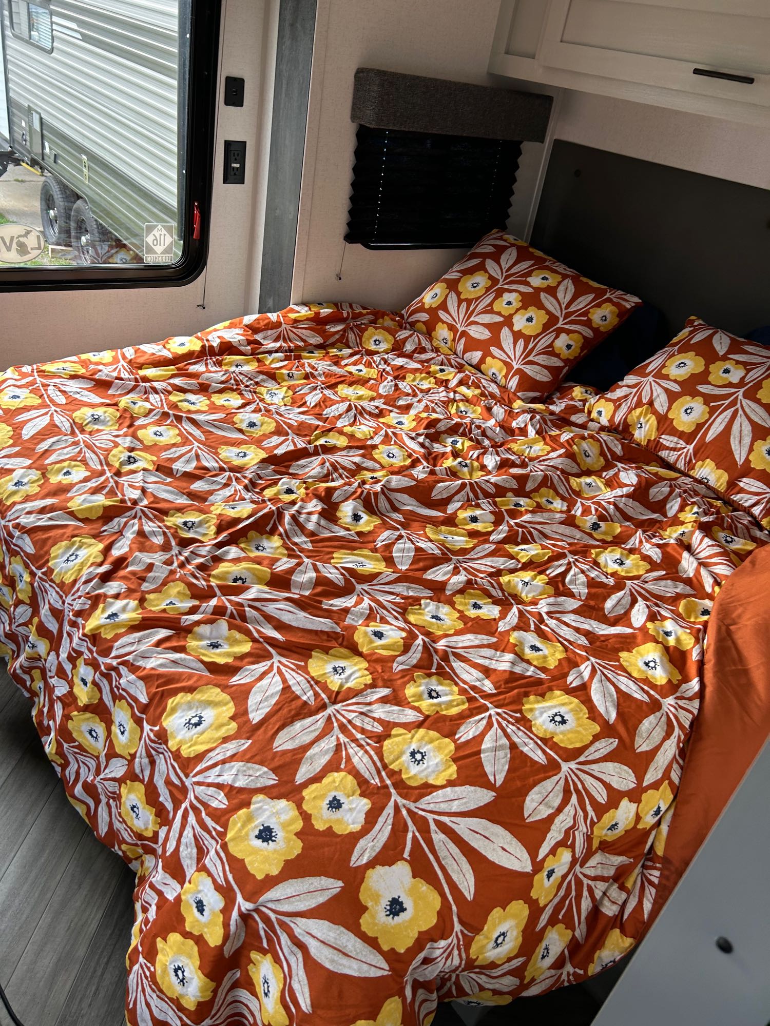 An inviting RV rental bedroom with colorful floral bedding, perfect for relaxing travel.. Forest River Salem FSX 2022