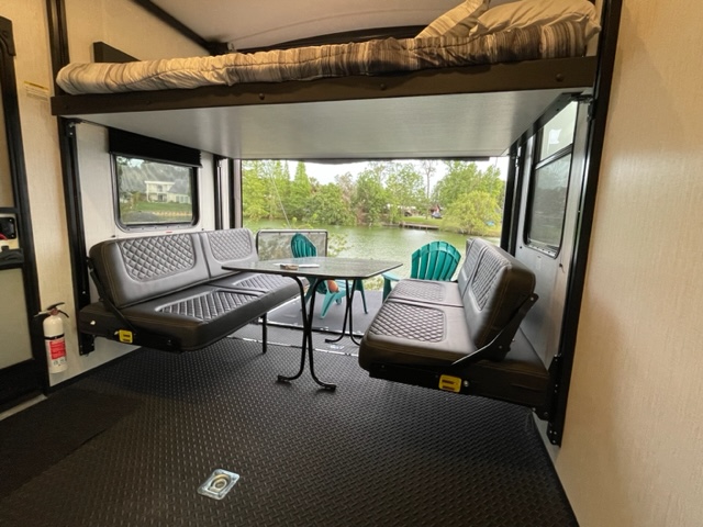 Relax in this RV rental's toy hauler patio with a stunning lake view, bunk bed, and comfy seating.. Heartland Torque 2023