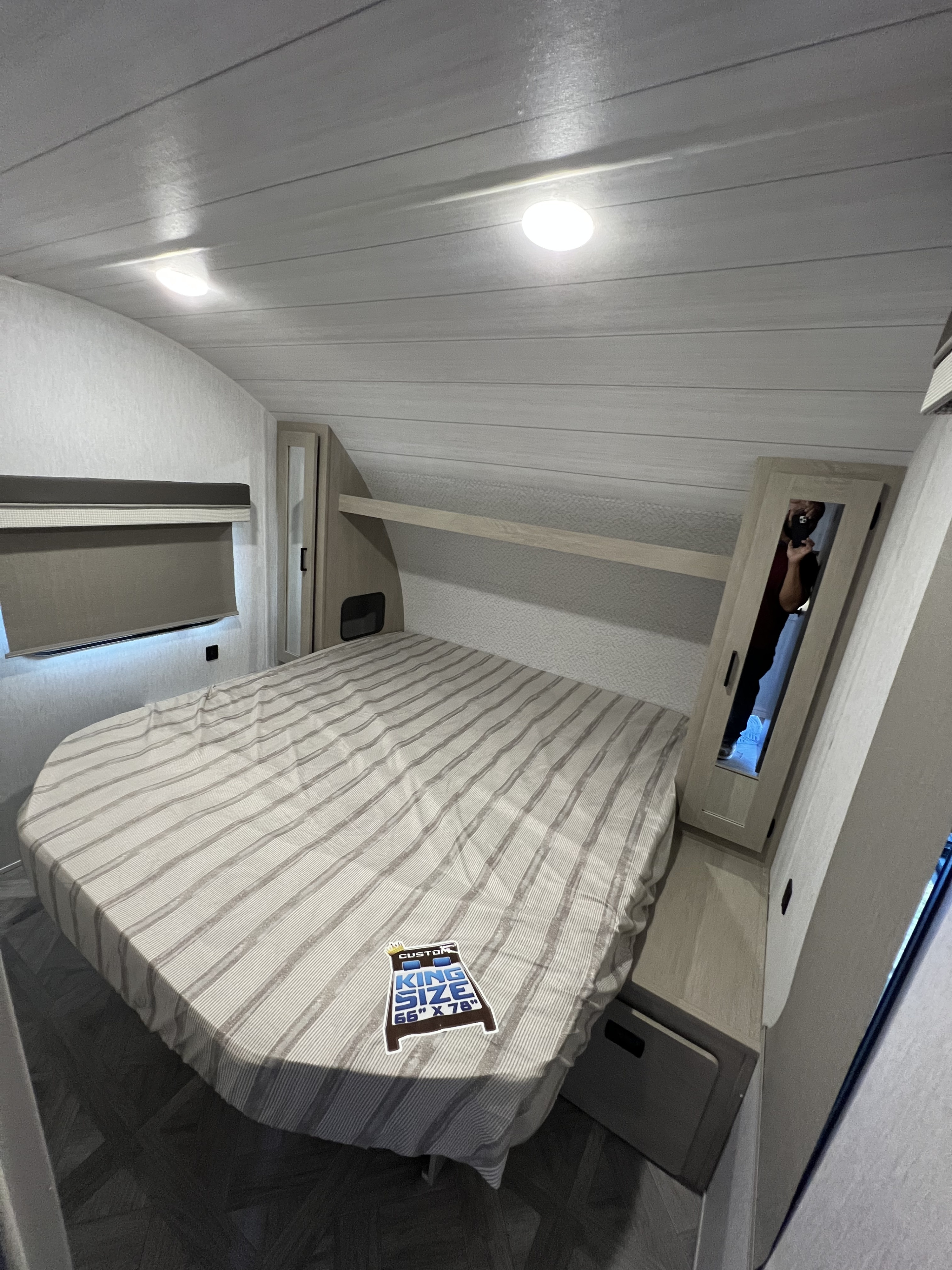 Cozy RV rental bedroom with custom 66"x78" king bed, built-in storage, and ambient lighting.. Forest River Salem cruise lite 2023